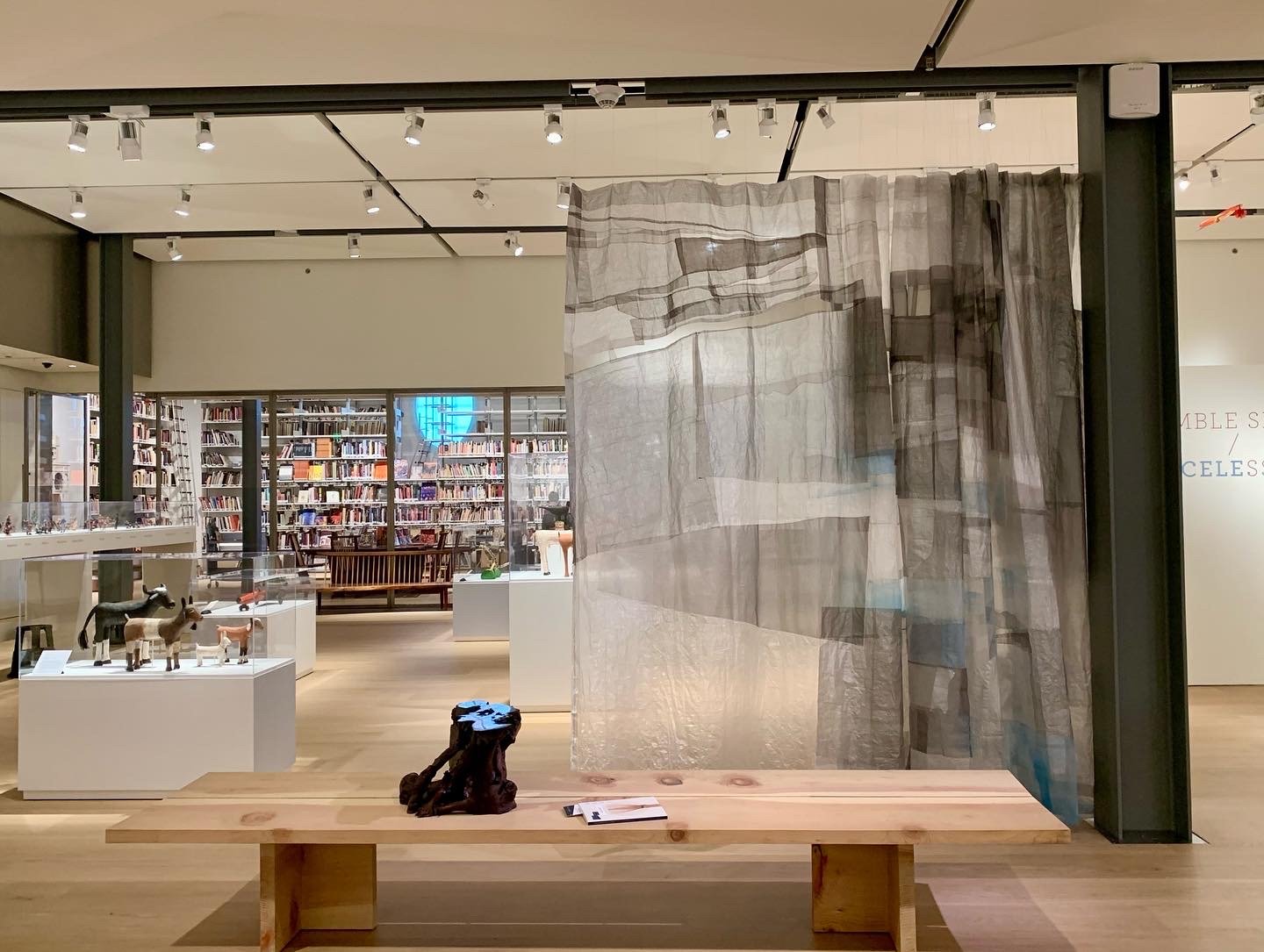   View towards the library with artist gallery bench “EAST/WEST”, a collaborative design effort between Jennifer Luce and Billy Tsien. Behind the bench is one of a series of flowing curtains in the gallery by Christina Kim 