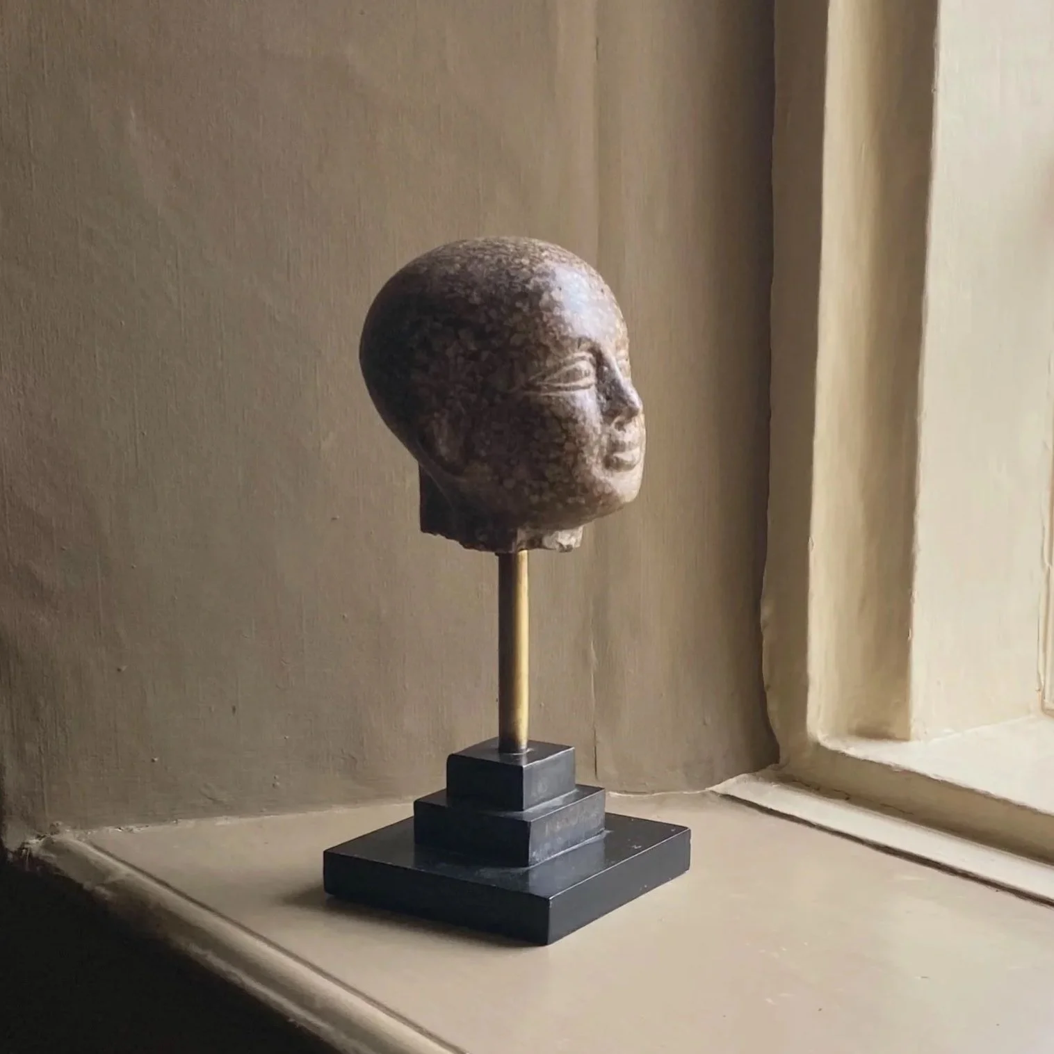 Museum Copy of an Egyptian Bust on Plinth