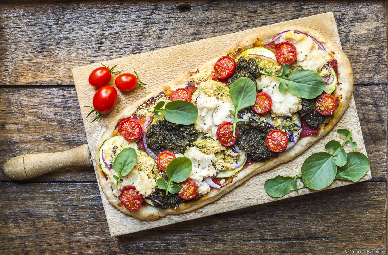 Almond ricotta and vegan parmesan on a zucchini, cherry tomato and pesto pizza, perfection!