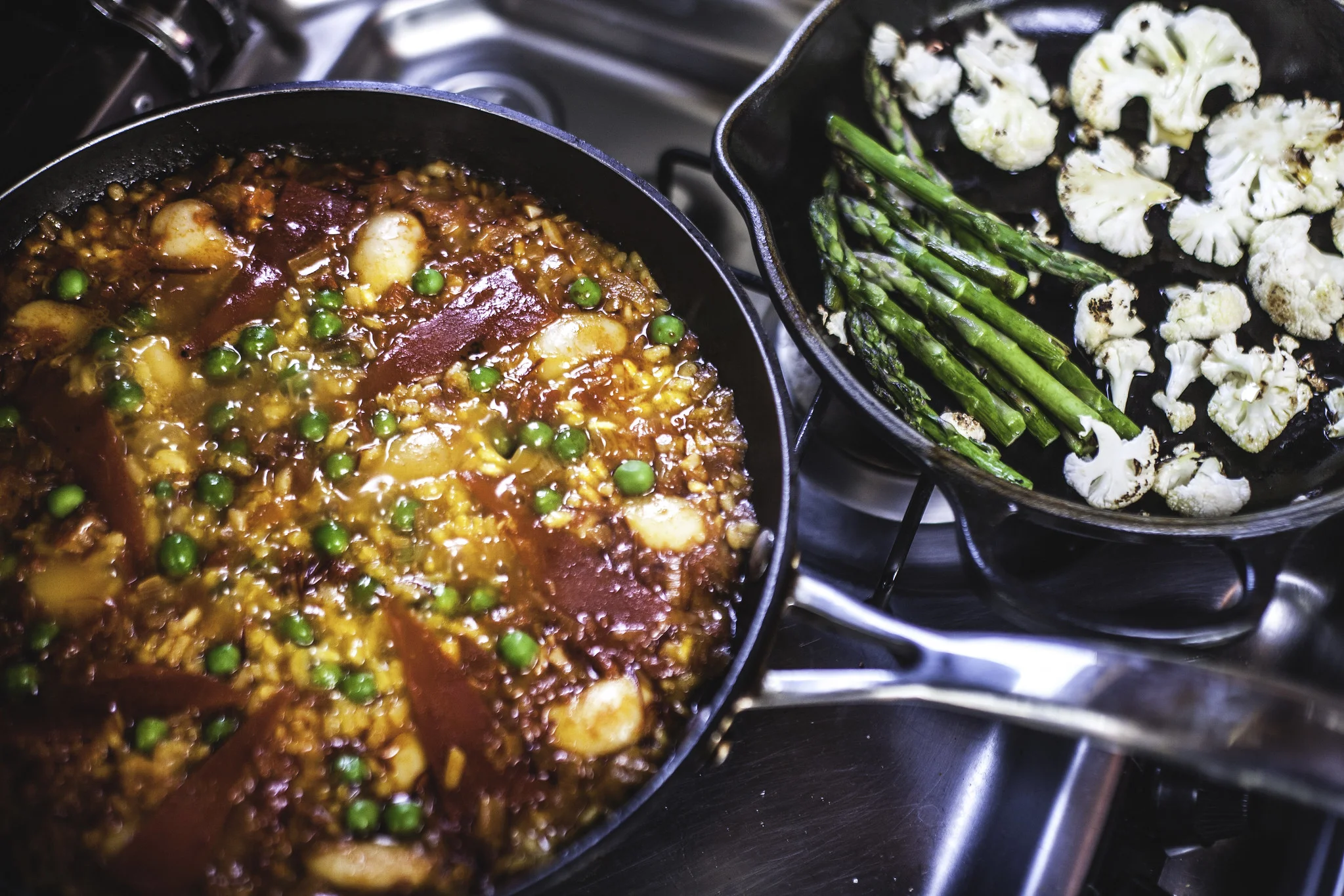 Add vegetables to the pan as the rice begins to absorb all the stock