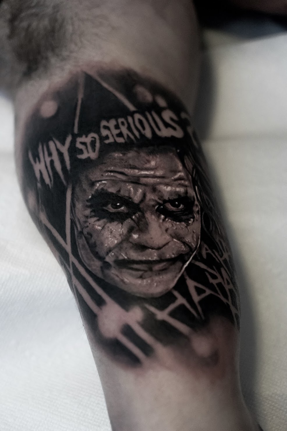 Photorealistic joker tattoo by Scoot Ink