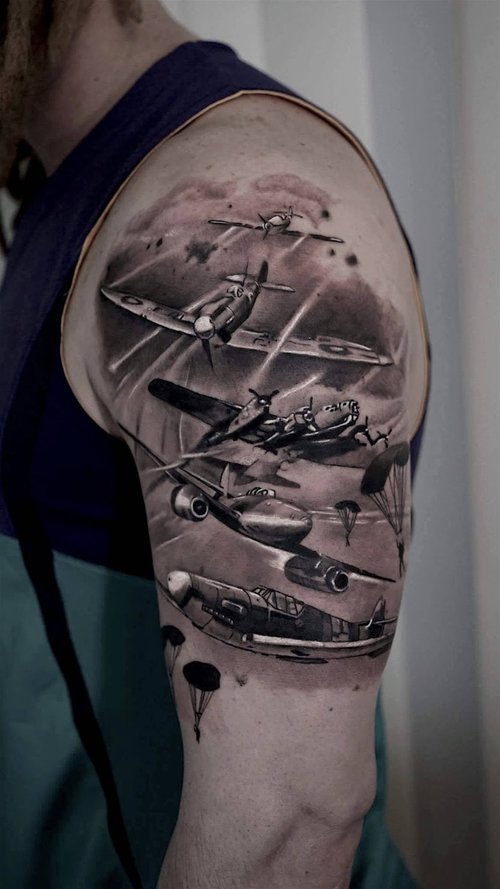 Photorealistic airplane dogfight tattoo by Scoot Ink