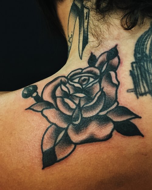 Traditional rose tattoo by German