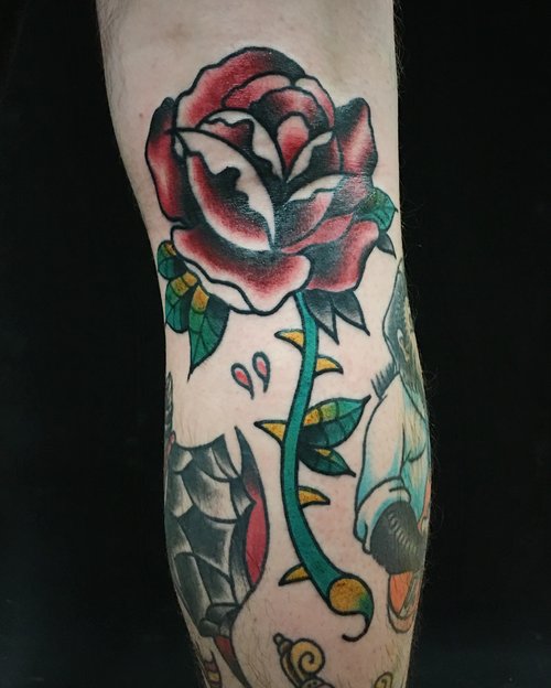 Traditional rose tattoo by German