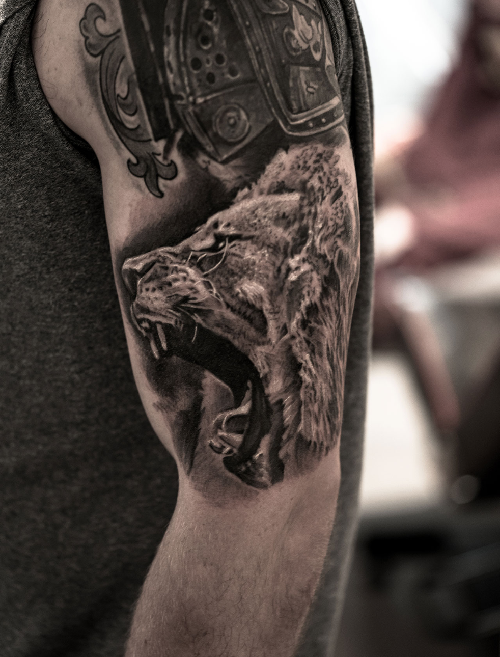 Photorealistic lion tattoo by Scoot Ink