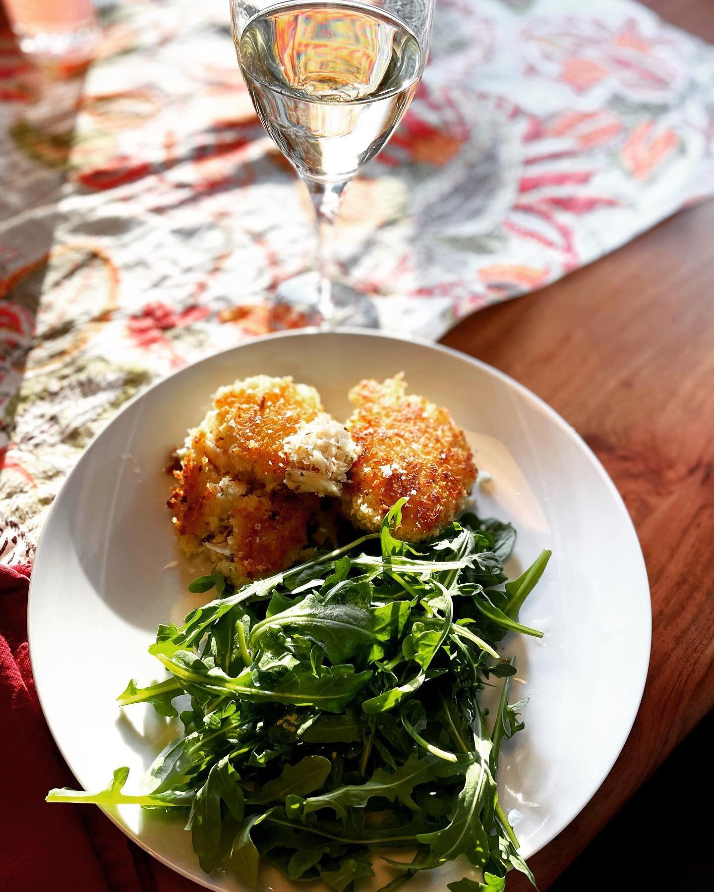 Dungeness Crab Cakes and arugula salad. The wine is cold and crisp and the crab is sweet and delicious. A real taste of California in Iowa.