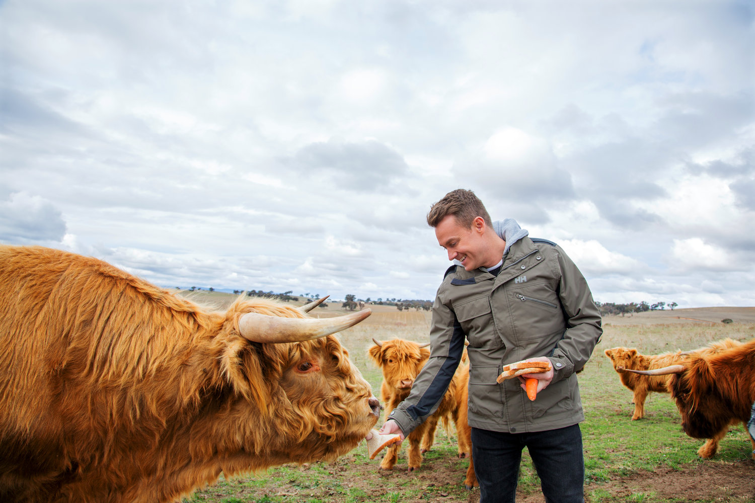 Grant Denyer feeds the cows