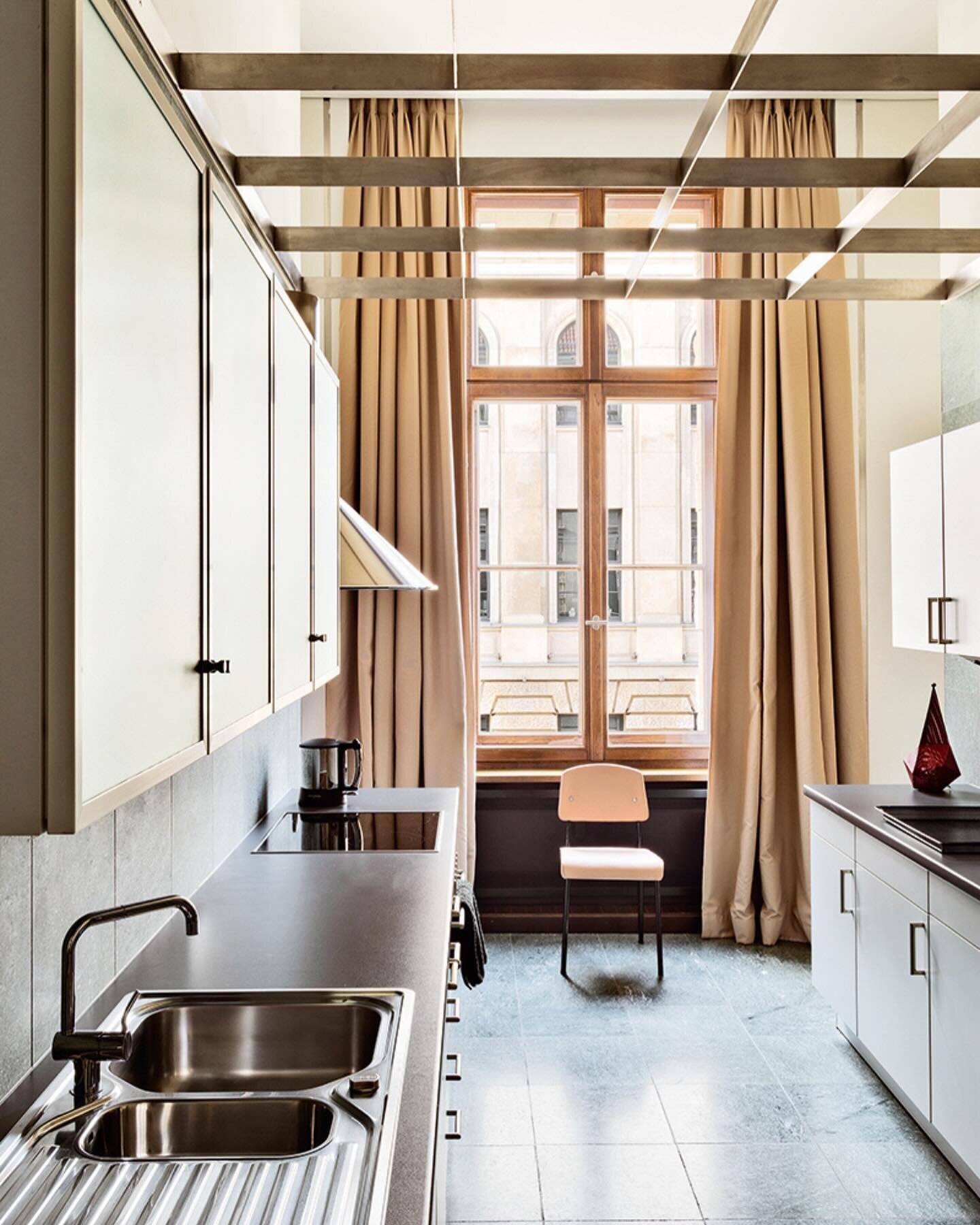 Industrial, elevated.

I&rsquo;ve always loved this kitchen, specifically for the way it marries a starkly industrial style cabinetry with elegant drapery (and that brilliant modernist dropped ceiling detail). However, I only recently realized how th