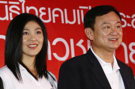 AsiaSociety: From left, Thai Prime Minister Yingluck Shinawatra, and her brother, former prime minister (2001-2006), Thaksin Shinawatra, who was charged with corruption in 2008.