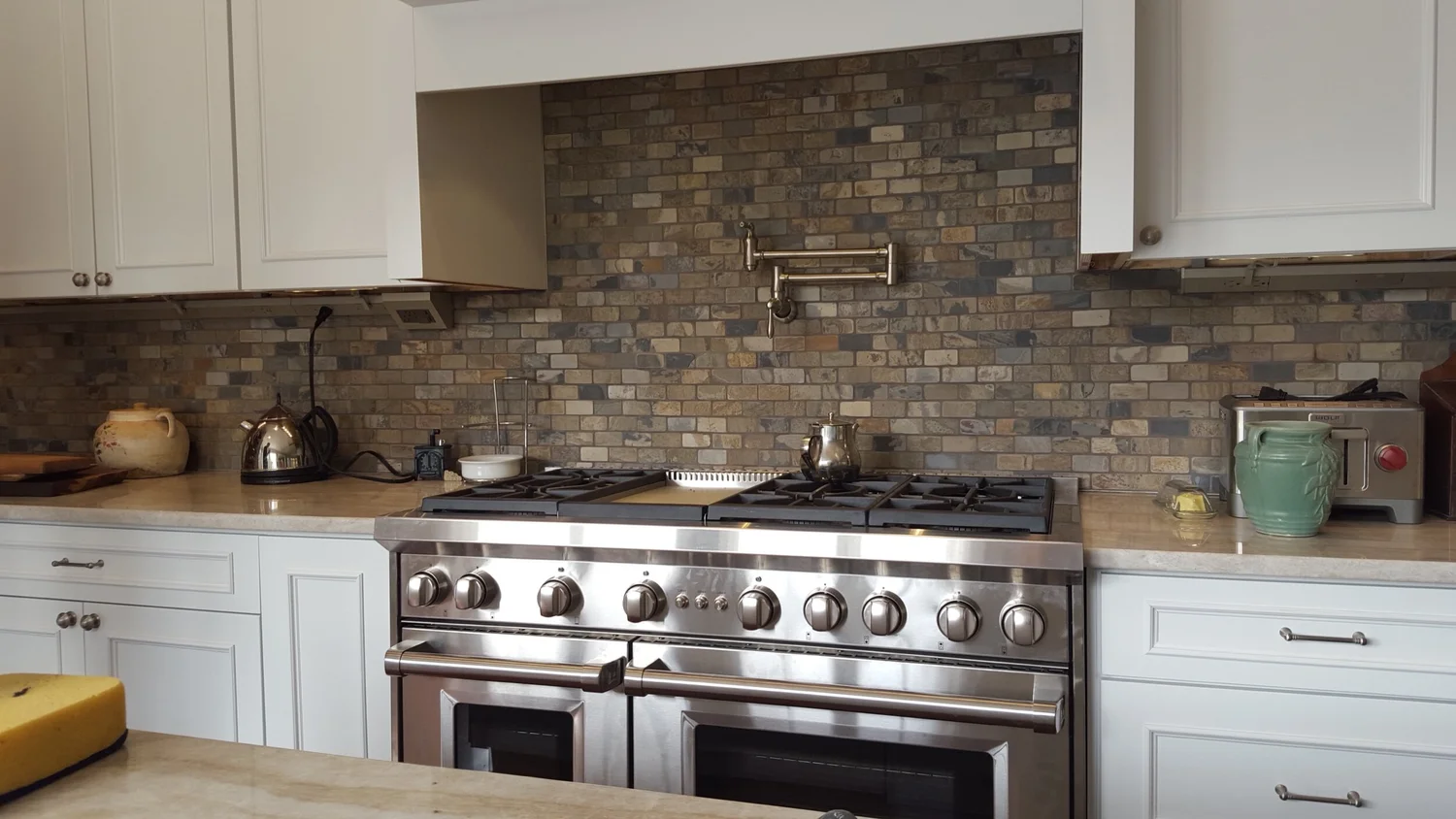 Kitchen remodeling contractor Syracuse stainless steel range with stone backsplash