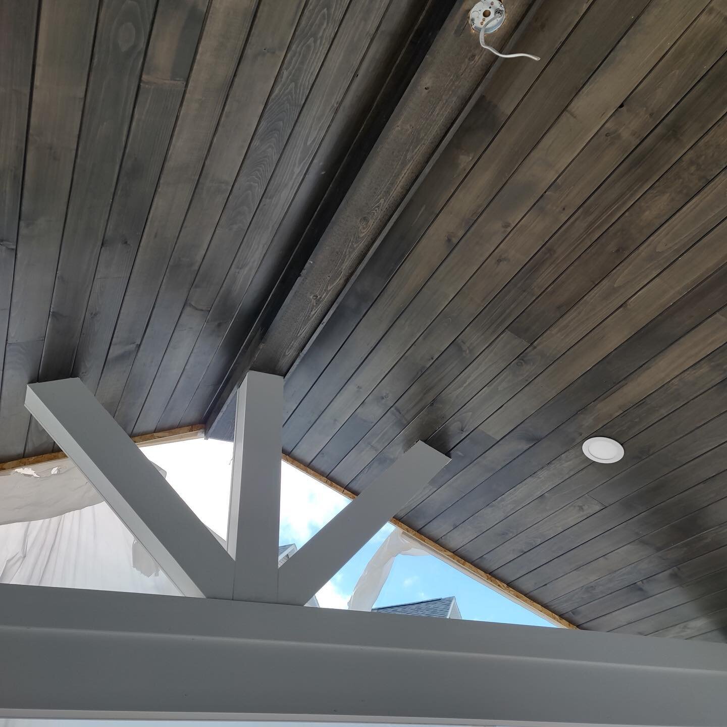 We really like the contrast between the dark stained wood ceiling and the white pvc brackets.  We used the same materials for the recessed tv paneling above fireplace.