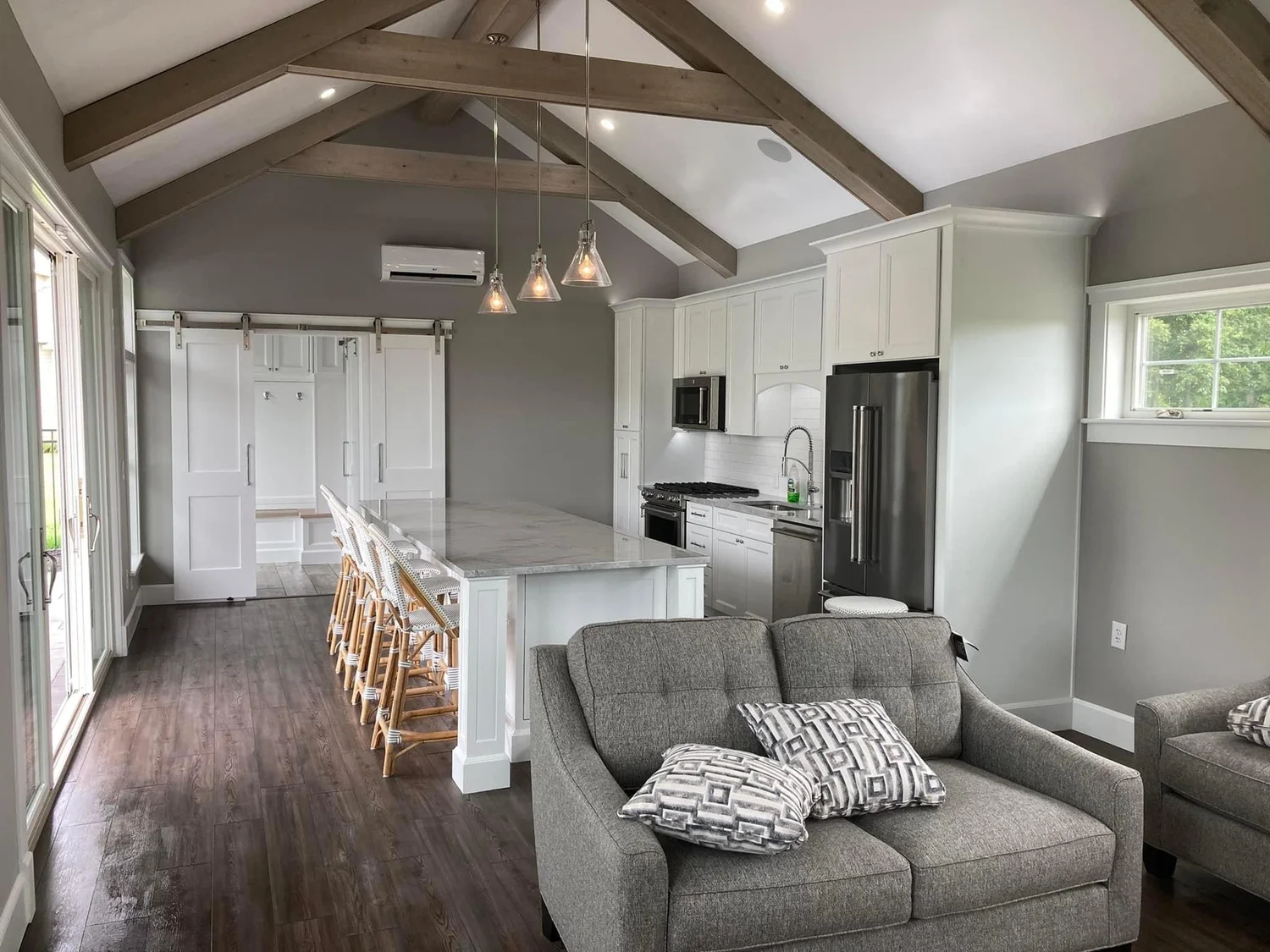Open-concept living space with vaulted ceiling and kitchen in a Syracuse home renovation