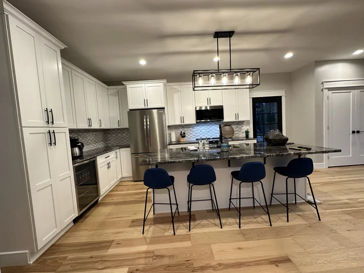 Kitchen remodeling Syracuse NY with white cabinets, island and stainless appliances