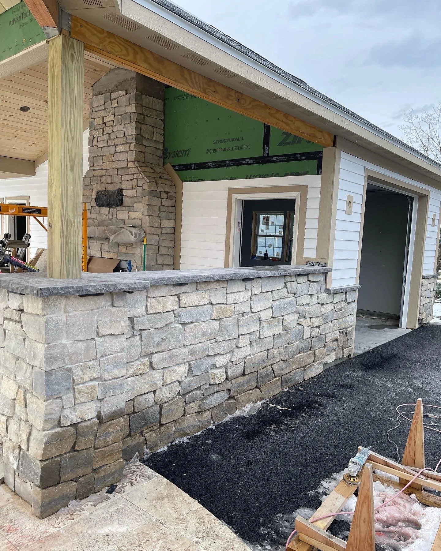 Exterior stone veneer wainscot installation on a home in Syracuse NY