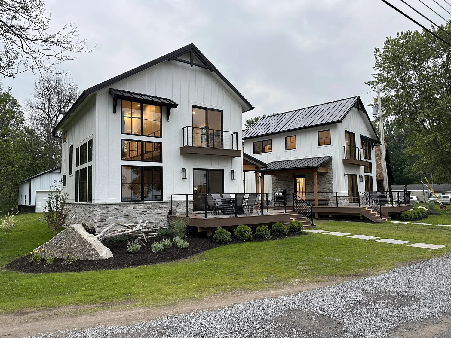 General contractor Syracuse NY completed modern farmhouse with stone base and deck