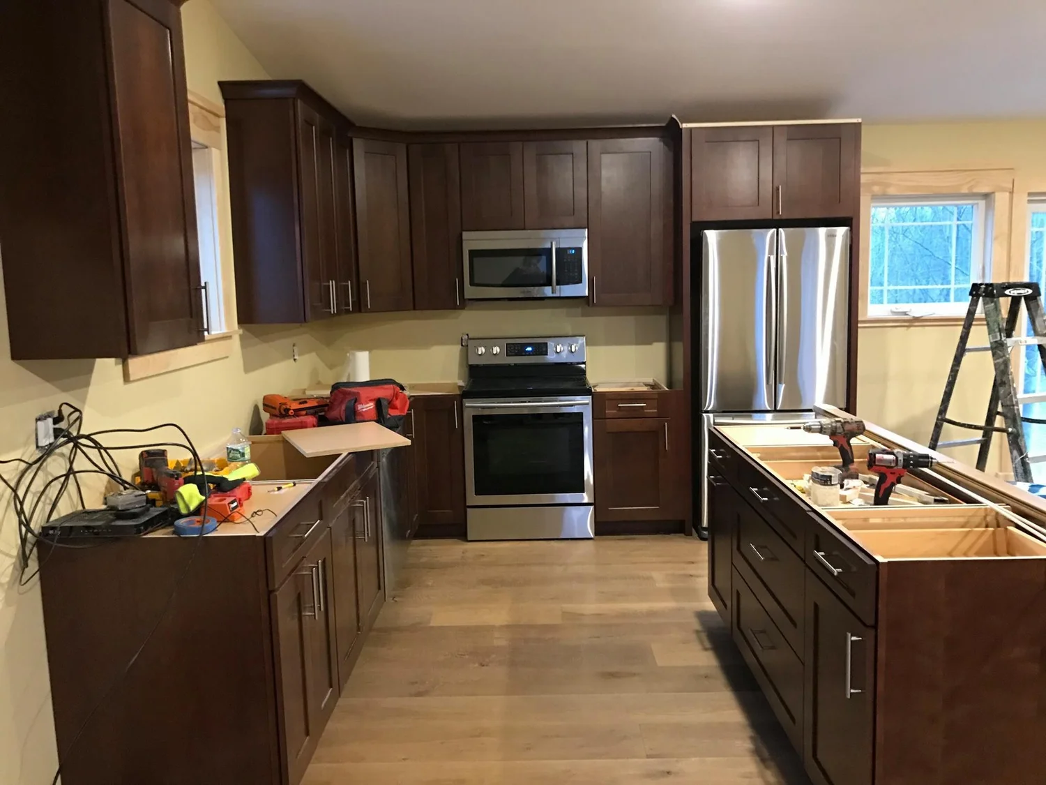 Kitchen renovation Syracuse with dark wood cabinets, island and stainless appliances