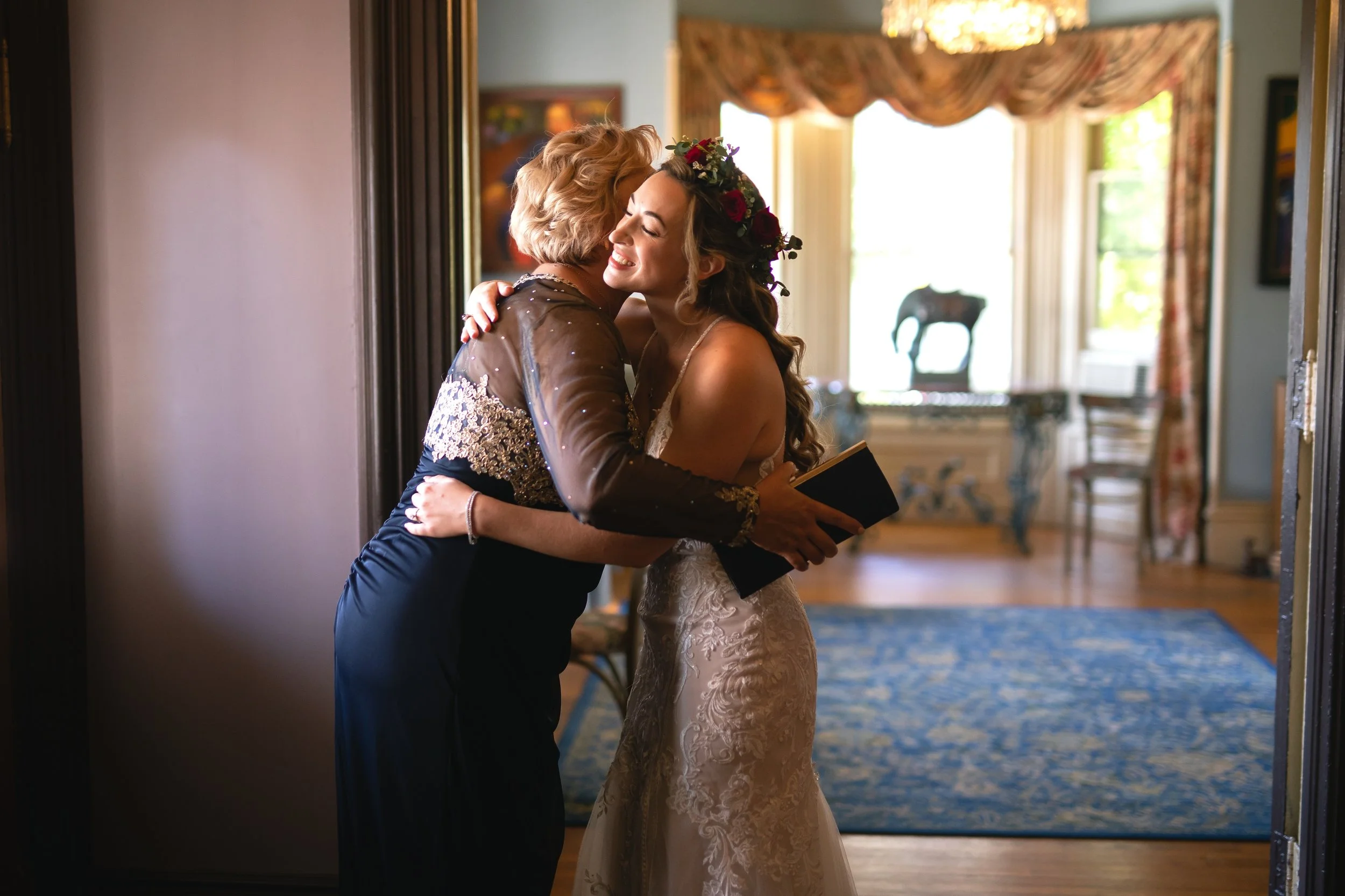 Bride hugs wedding guests inside FEAST at Round Hill Wedding Venue