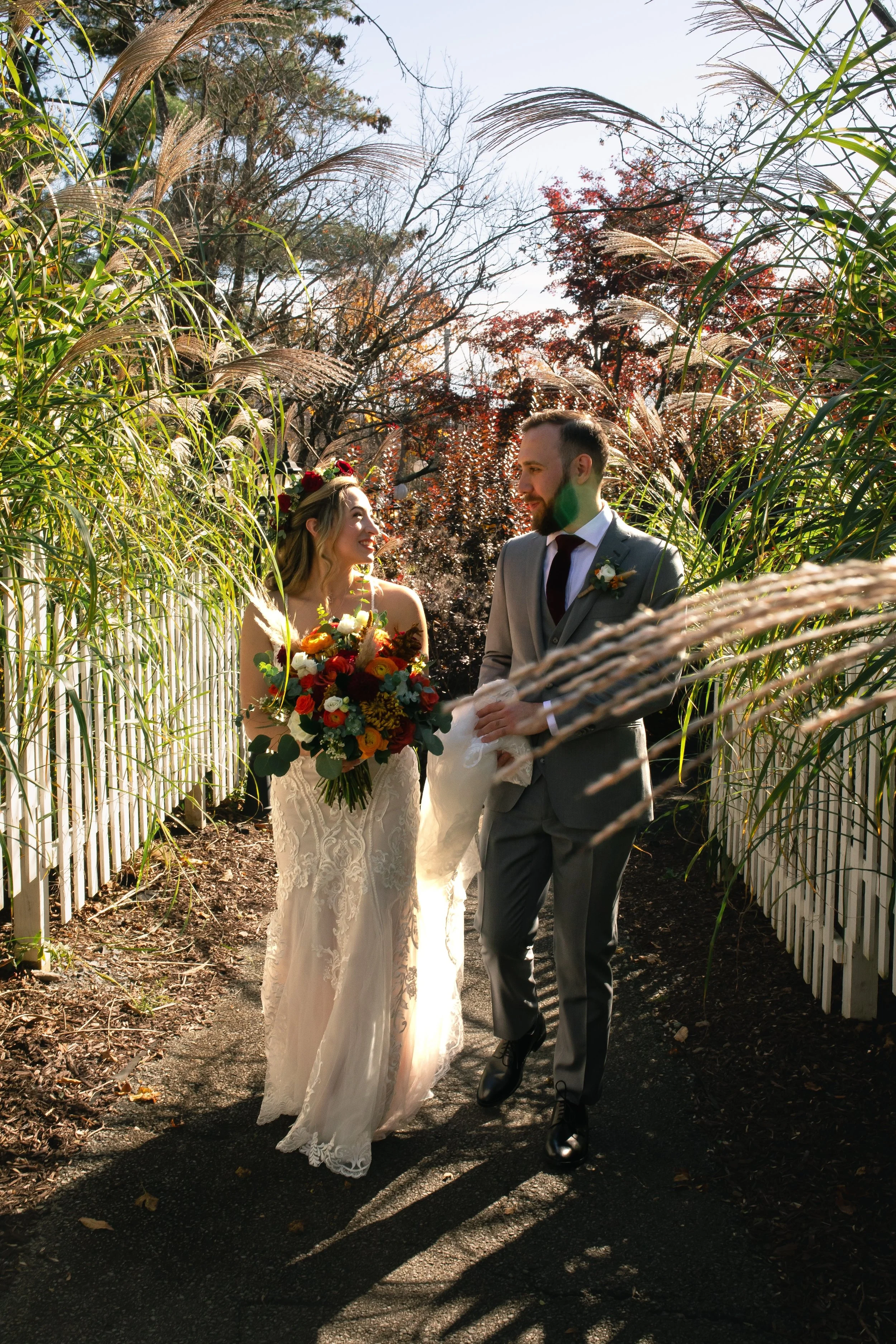 Bride and groom looking at each other outside in gardens at FEAST at Round Hill Wedding Venue in Upstate NY