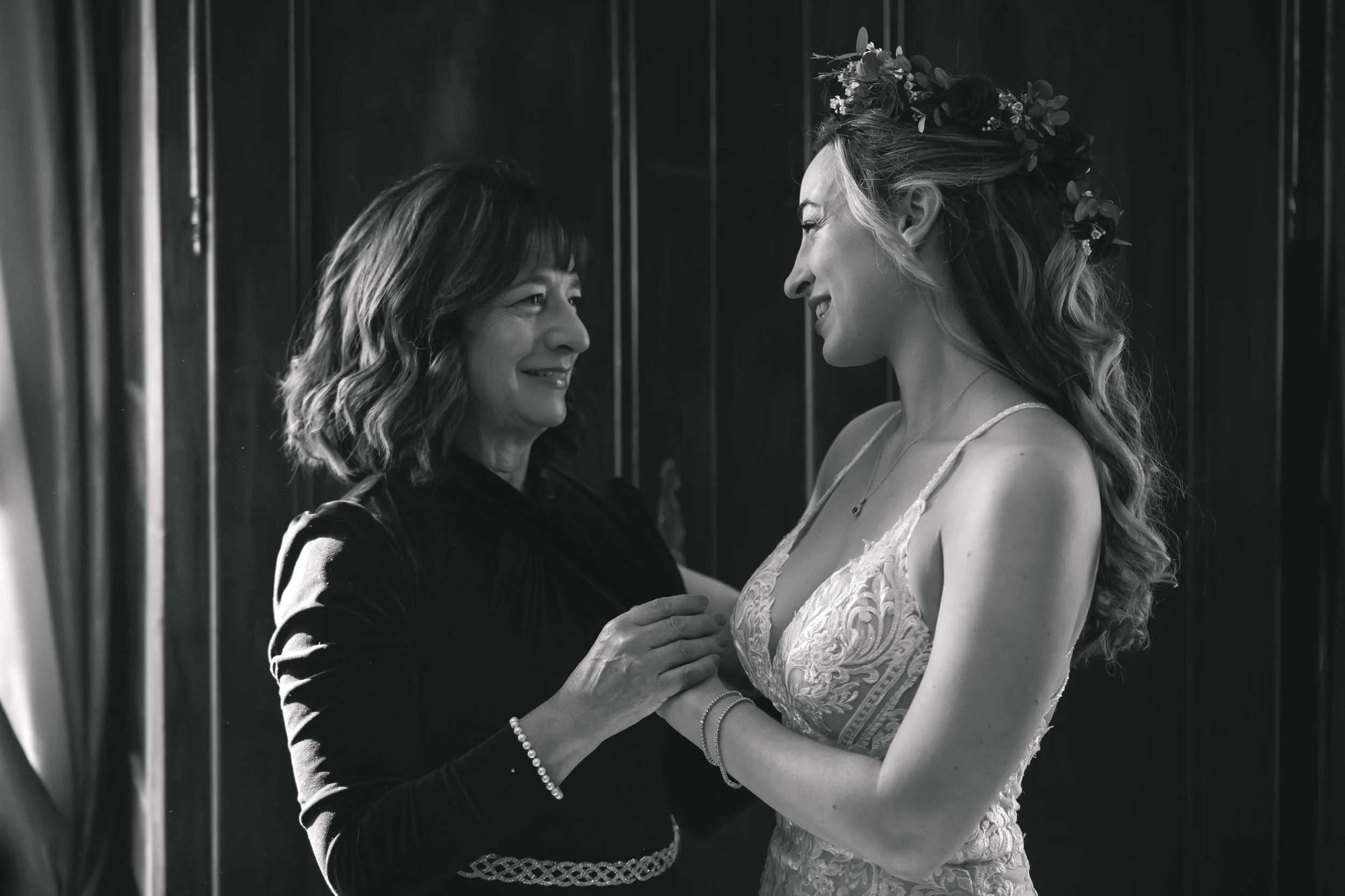 Bride and mother smiling while getting ready before ceremony at FEAST at Round Hill Wedding Venue
