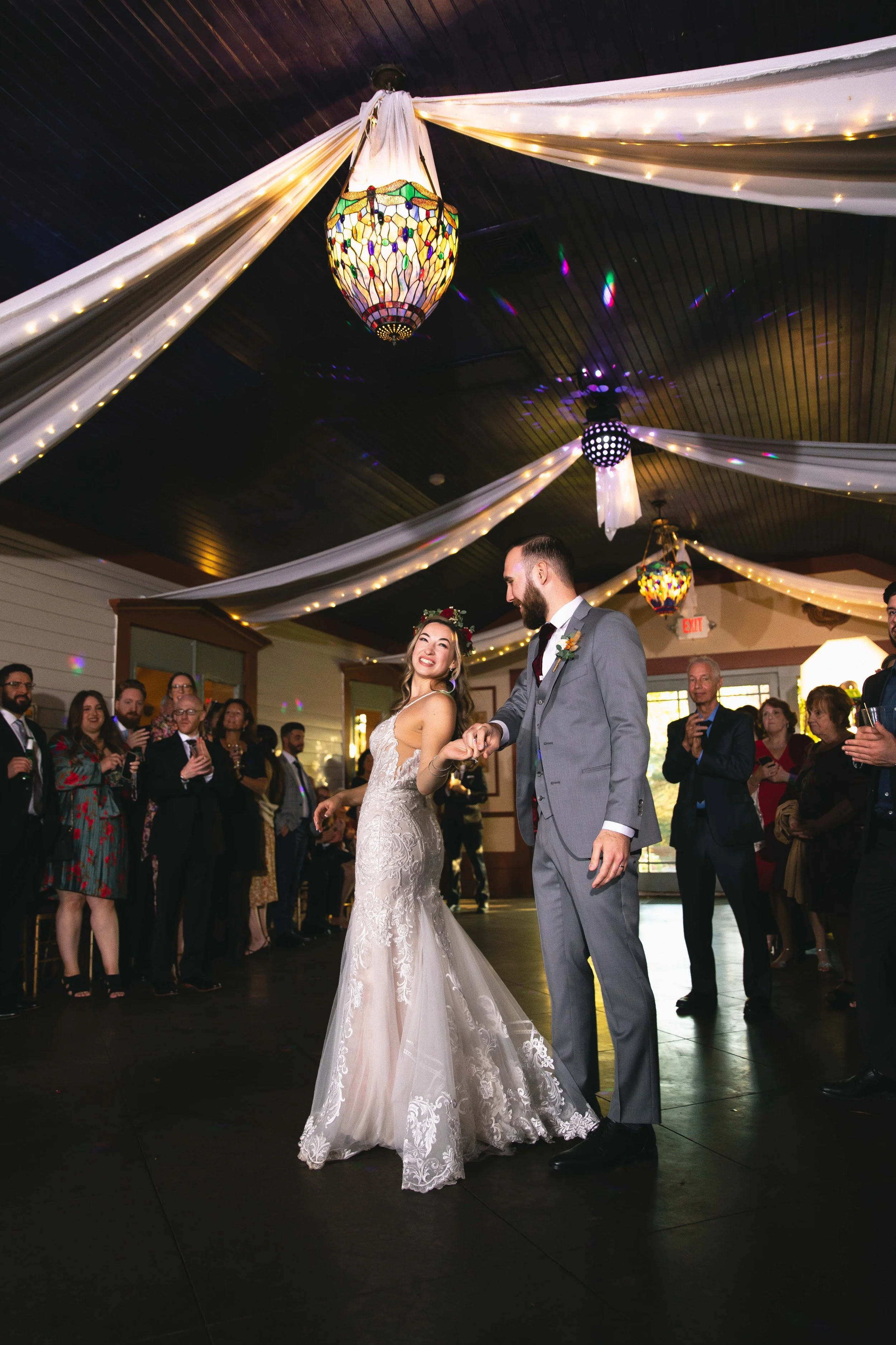 Bride and groom first dance in ballroom with wedding crowd at FEAST at Round Hill in Washingtonville, NY