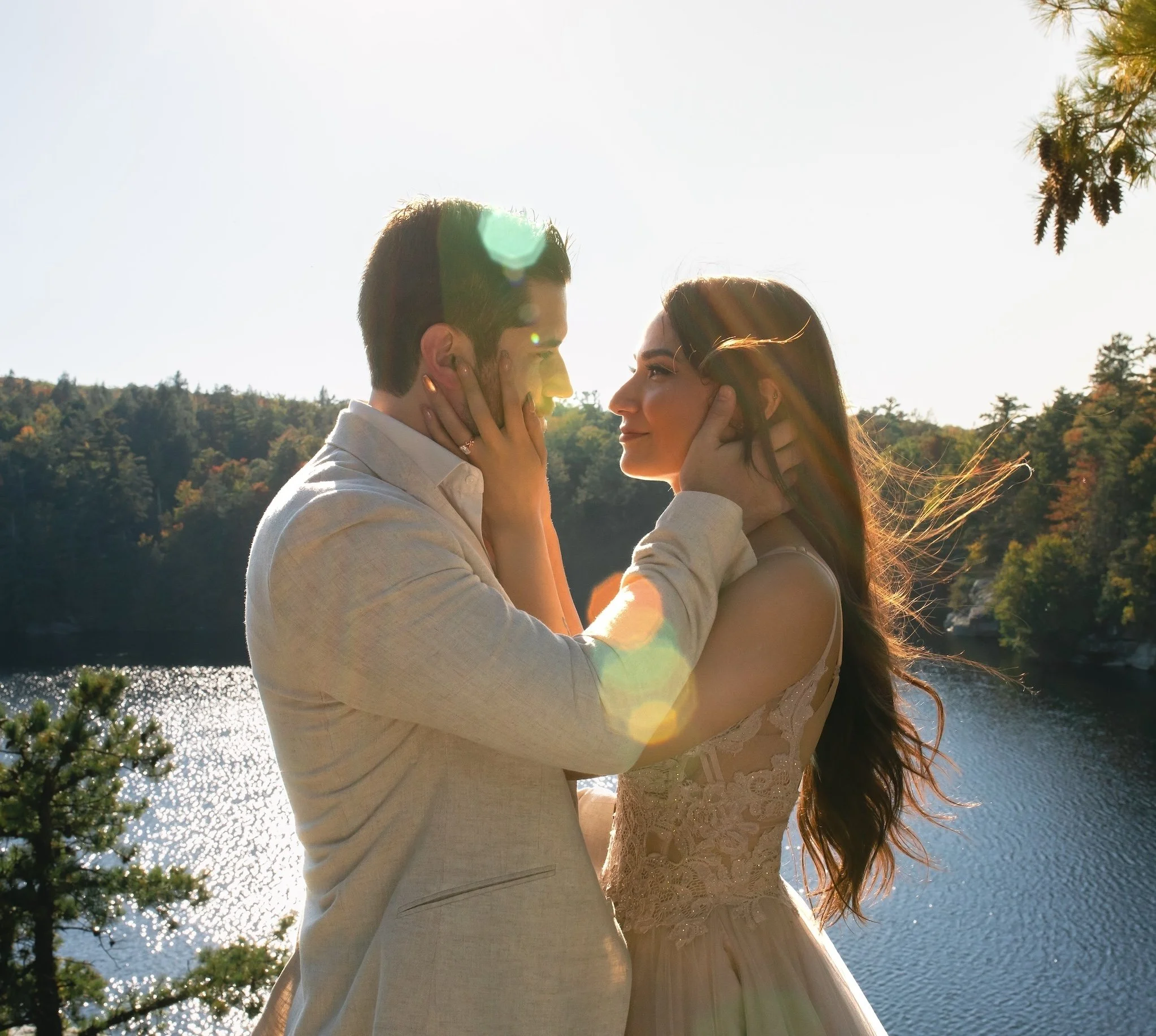 Wedding Couple holding each other in sunlight at Minnewaska Lake State Park during engagement session