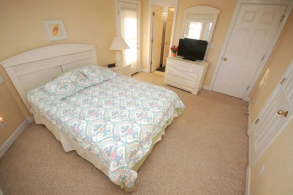 Main Floor Queen Bedroom with connected Jack and Jill Bathroom and Access to Wrap Around Decks.jpg