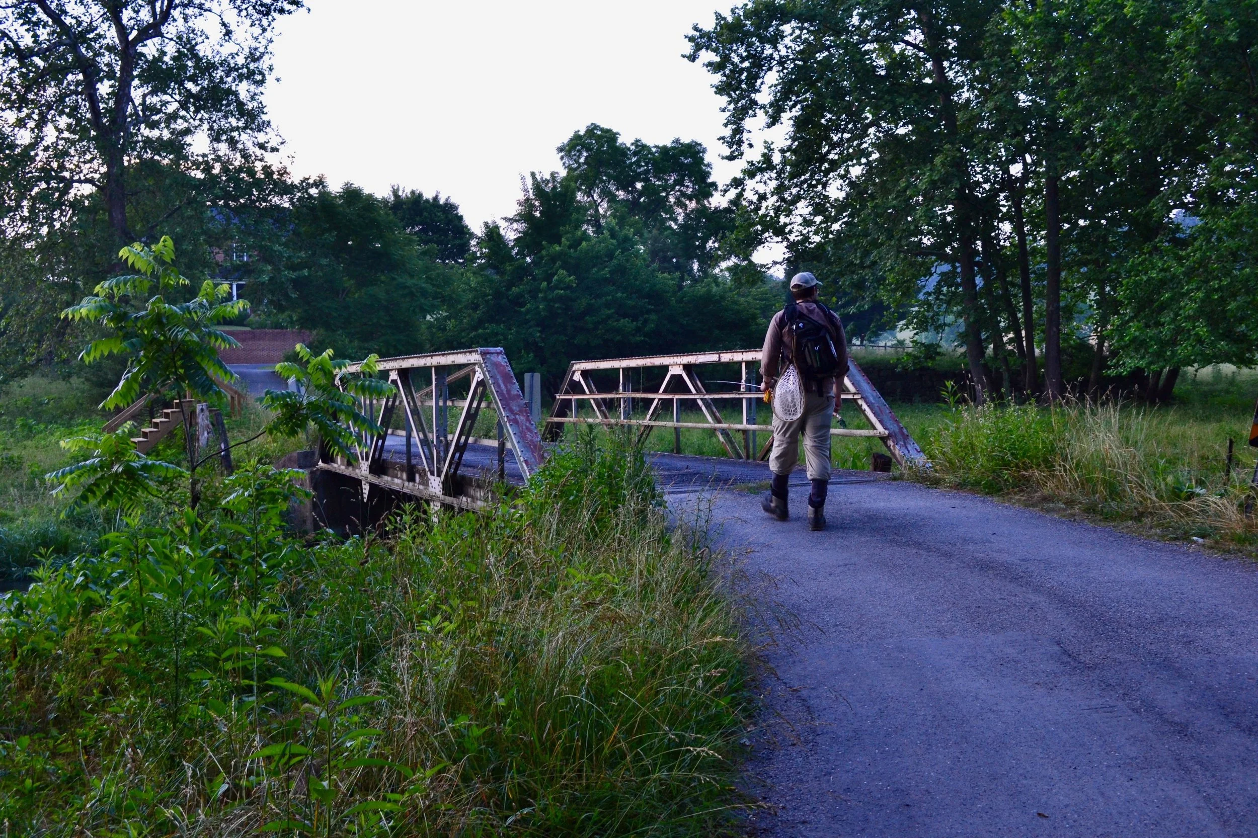 An early morning search for rising trout. Photograph by Miranda Martin. What you don't see is, Evie, our little baby catching a ride on the front of me...