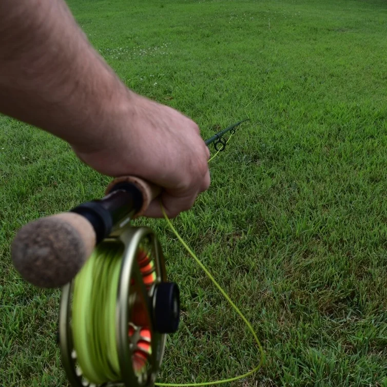 Good line management. Notice the hand is gripping the line while holding the cork, and there's no slack all the way up the rod towards the fly. 