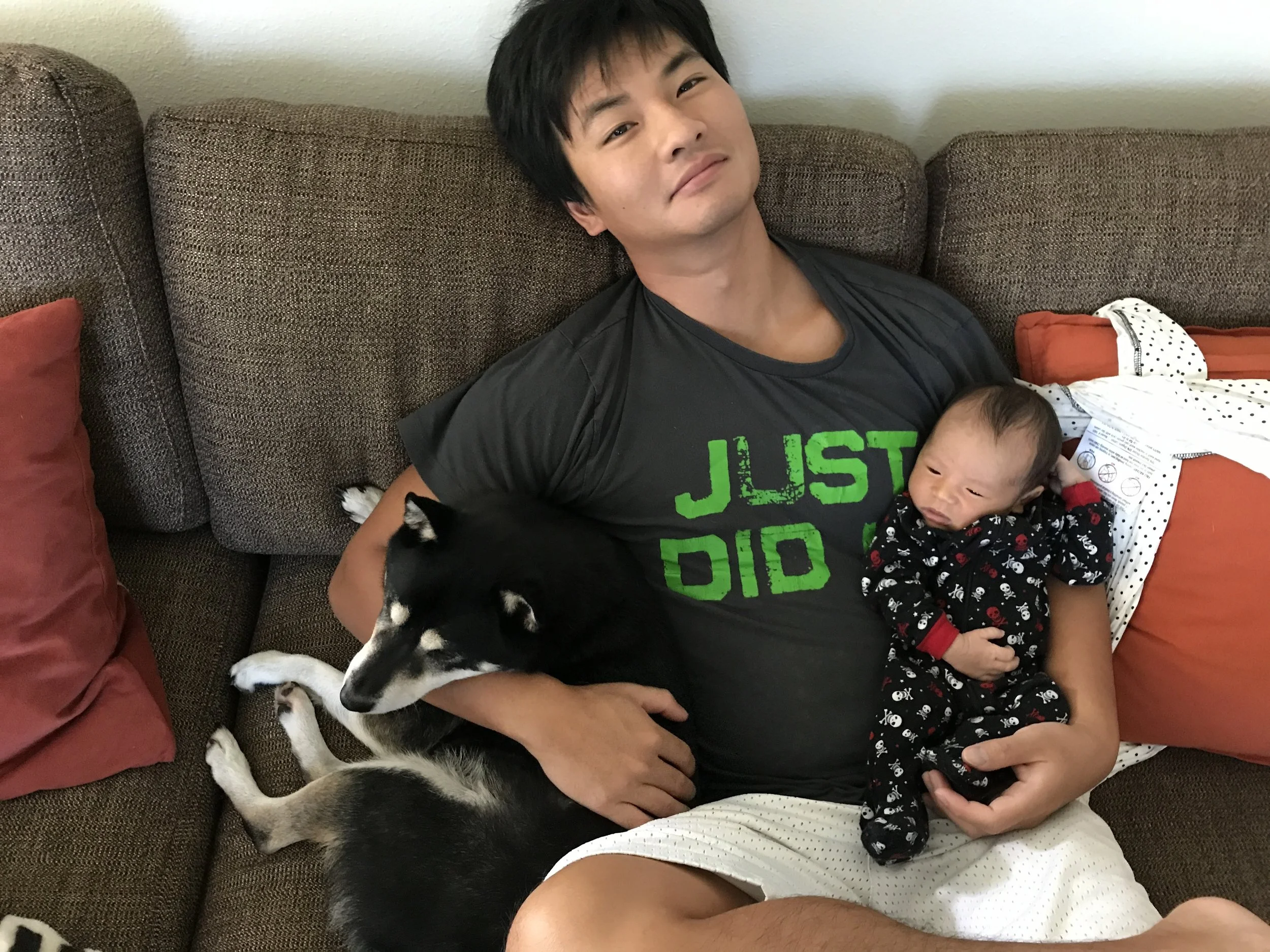 Jian has his dog and his baby in his arms. He is content. :)
