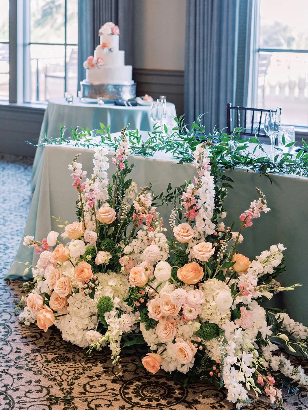 Repurposing florals from the ceremony to in front of the sweetheart table is a simple way to make everything feel cohesive while getting to enjoy those beautiful arrangements all night long 🩷

Wedding Team:
Venue: @tpcsawgrassweddings 
Planner: @fir