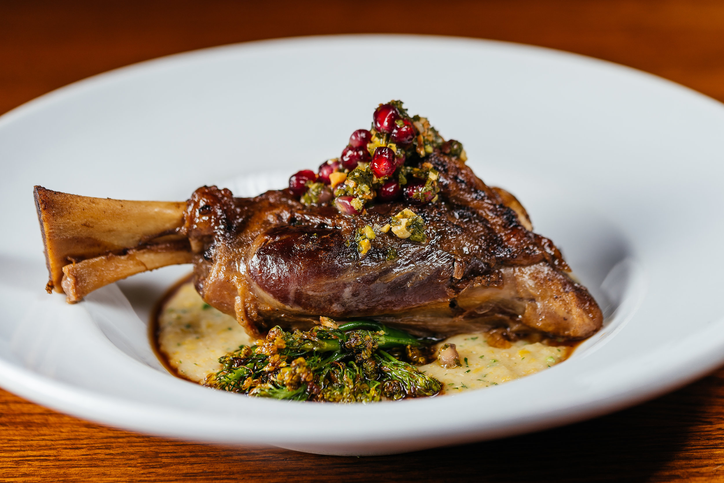Braised lamb shank with creamy polenta, balsamic broccolini, and walnut pistou