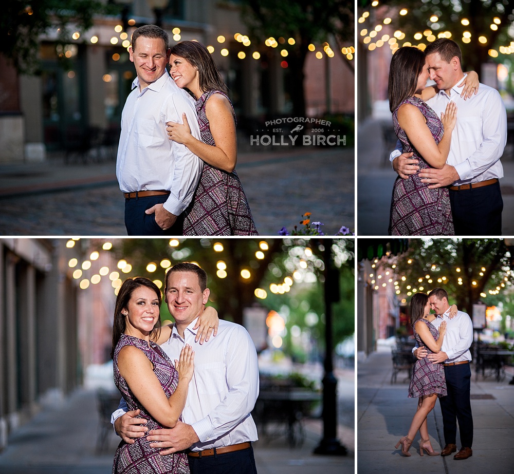 couple posing on Laclede's landing brick street with cafe light bulbs