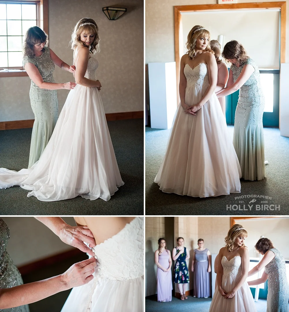 mother of the bride helping bride into dress