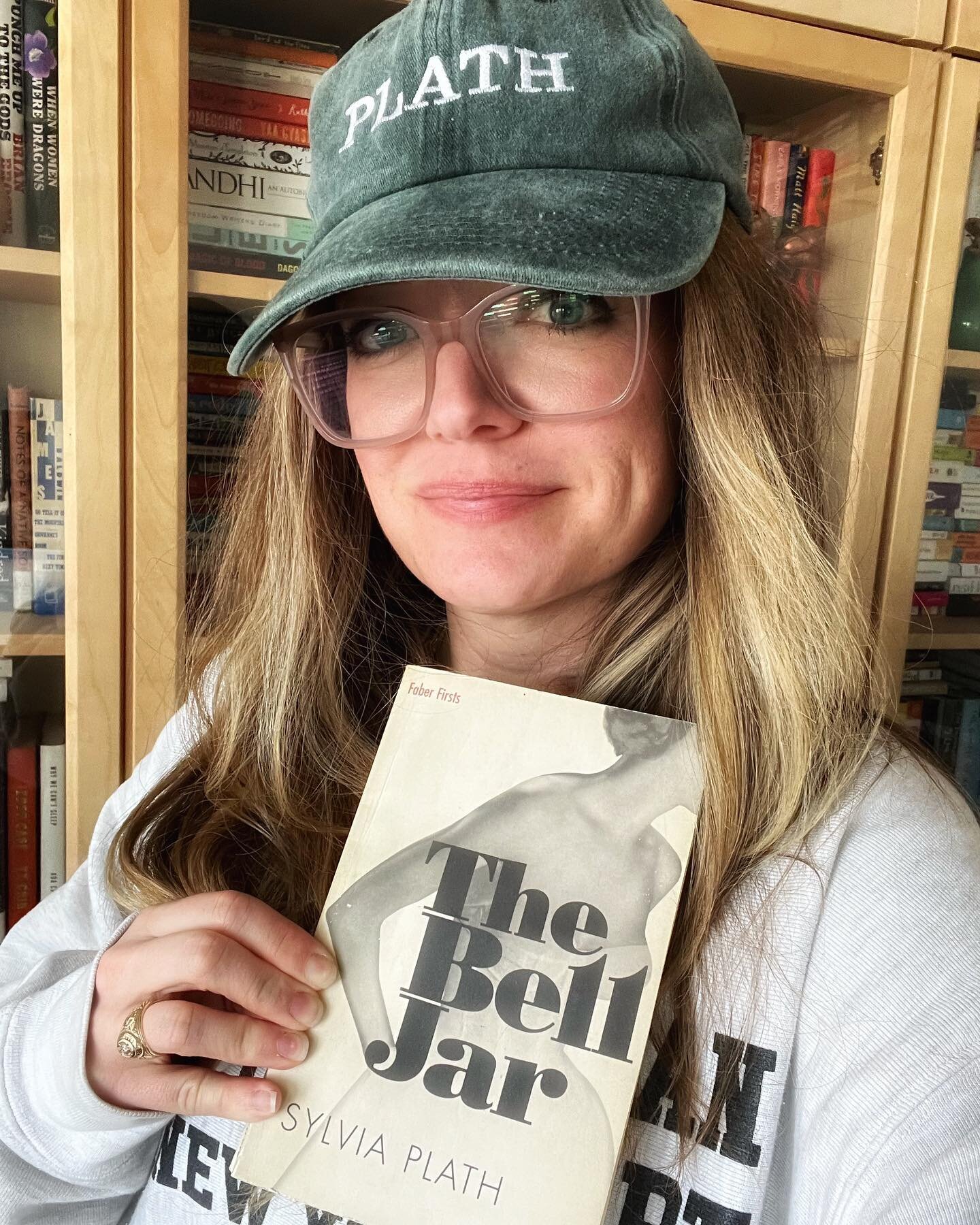 It&rsquo;s me, hi and it&rsquo;s february which means it is time for my annual read of #thebelljar in memory of the great Sylvia Plath, my favorite writer of all time. || sporting my @wombhousebooks hat 🧢