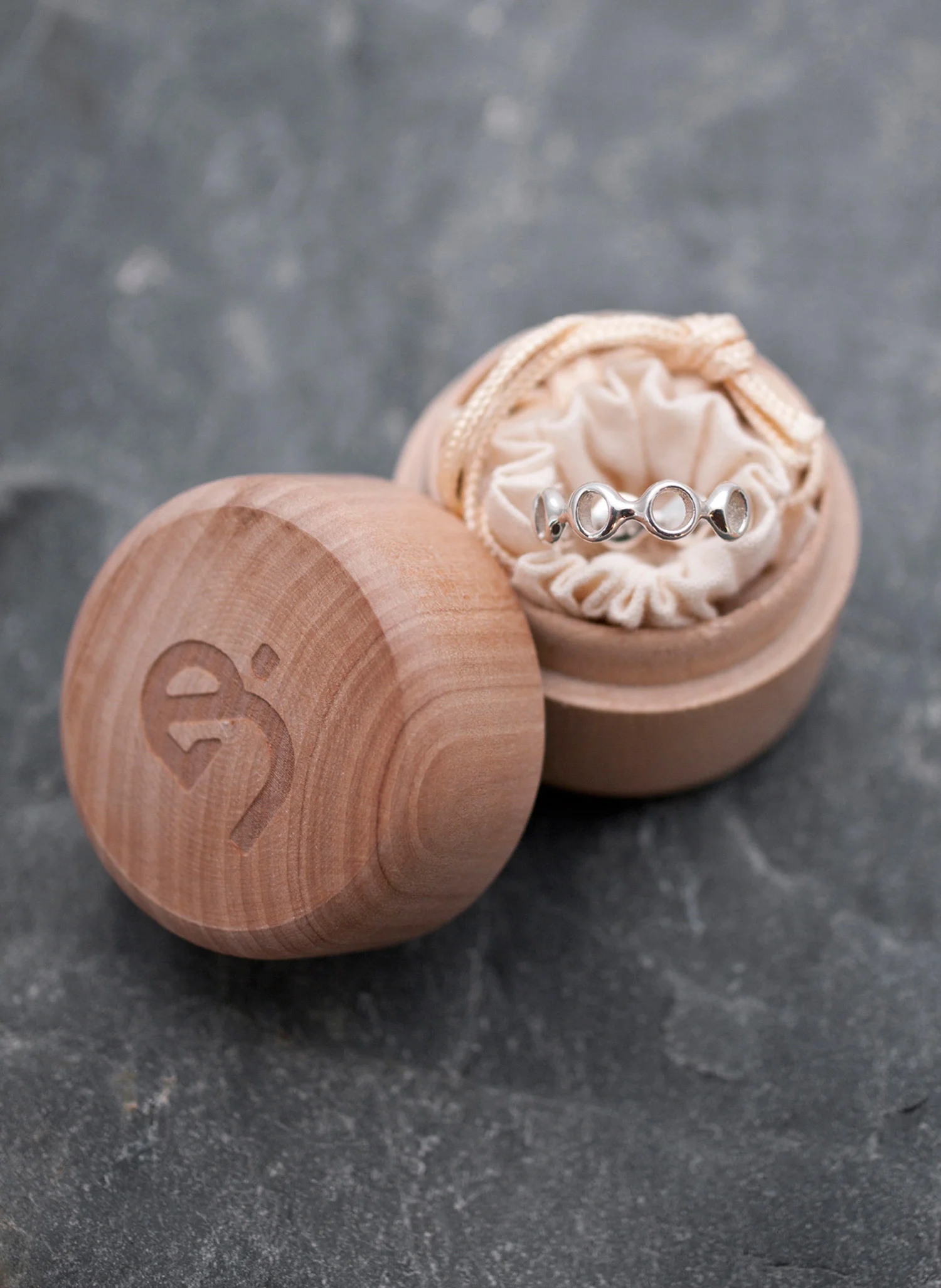 Lunar Ring in wood box packaging on rocks