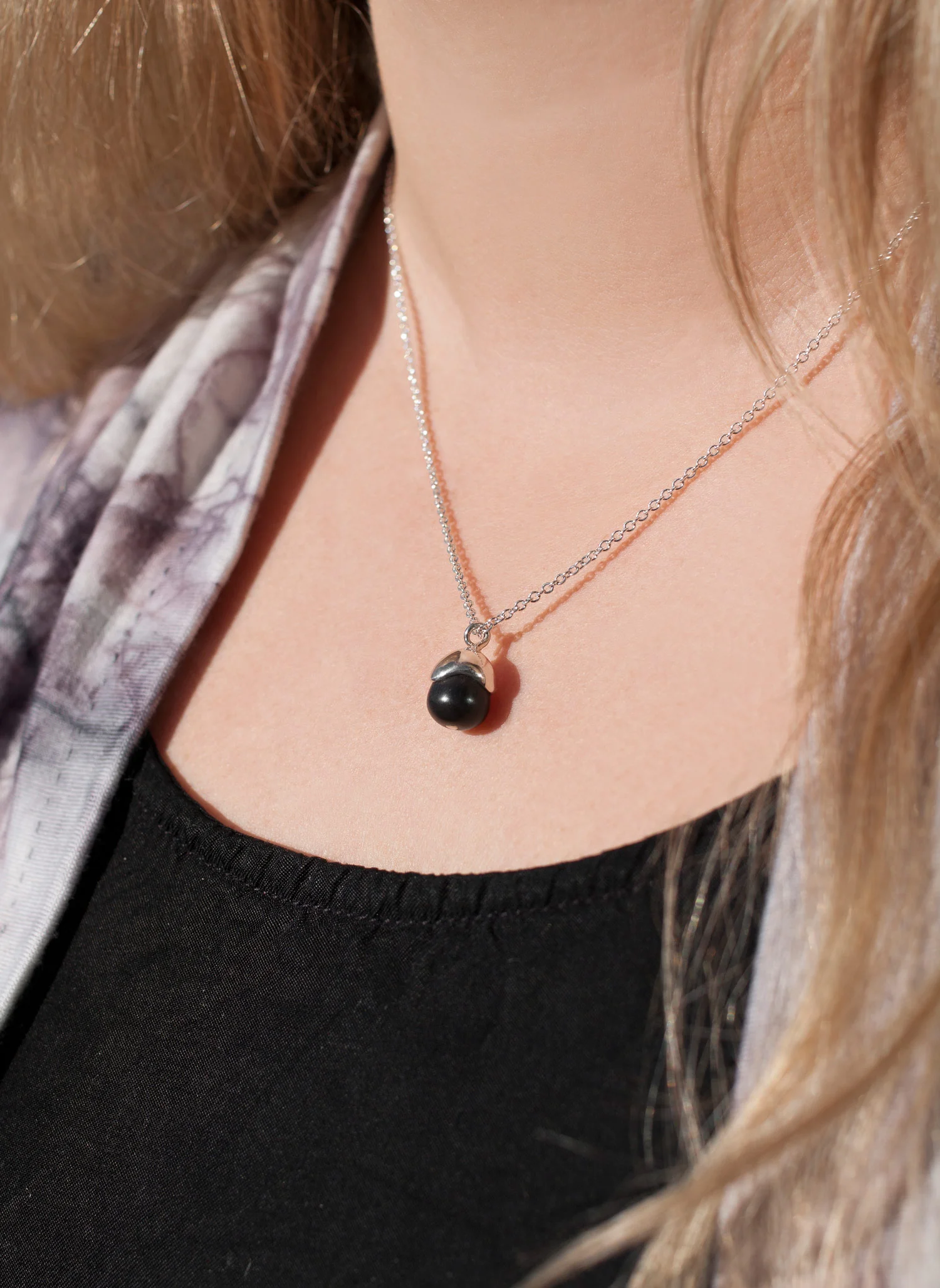 acorn pendant ebony wood and sterling silver mini size 10mm diameter worn by model