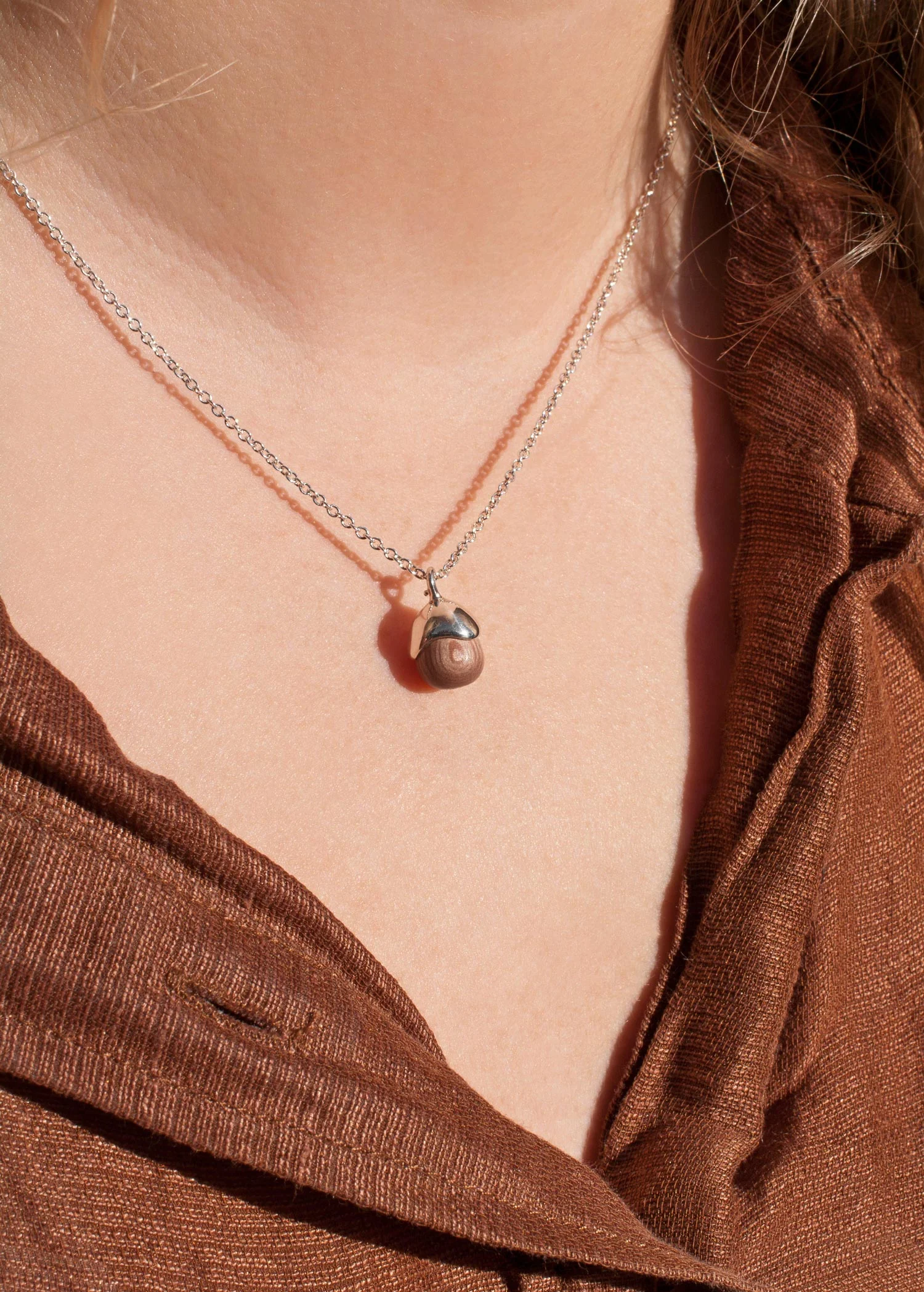 Acorn Pendant in rosewood and sterling silver mini size 10 diameter worn by model