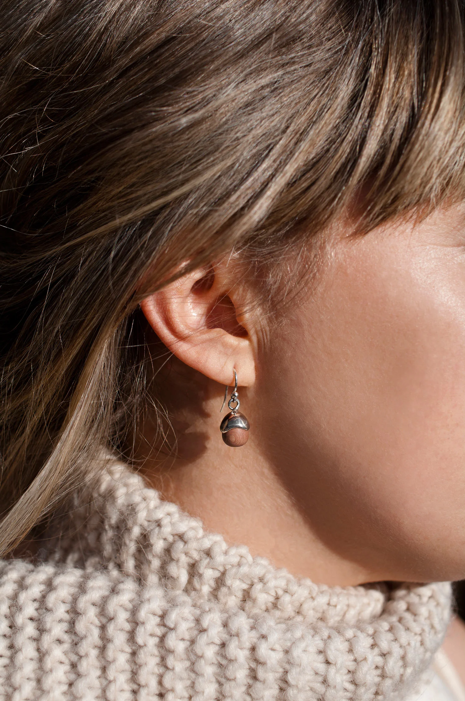 Acorn Earrings rosewood and sterling silver small size worn by model in natural light