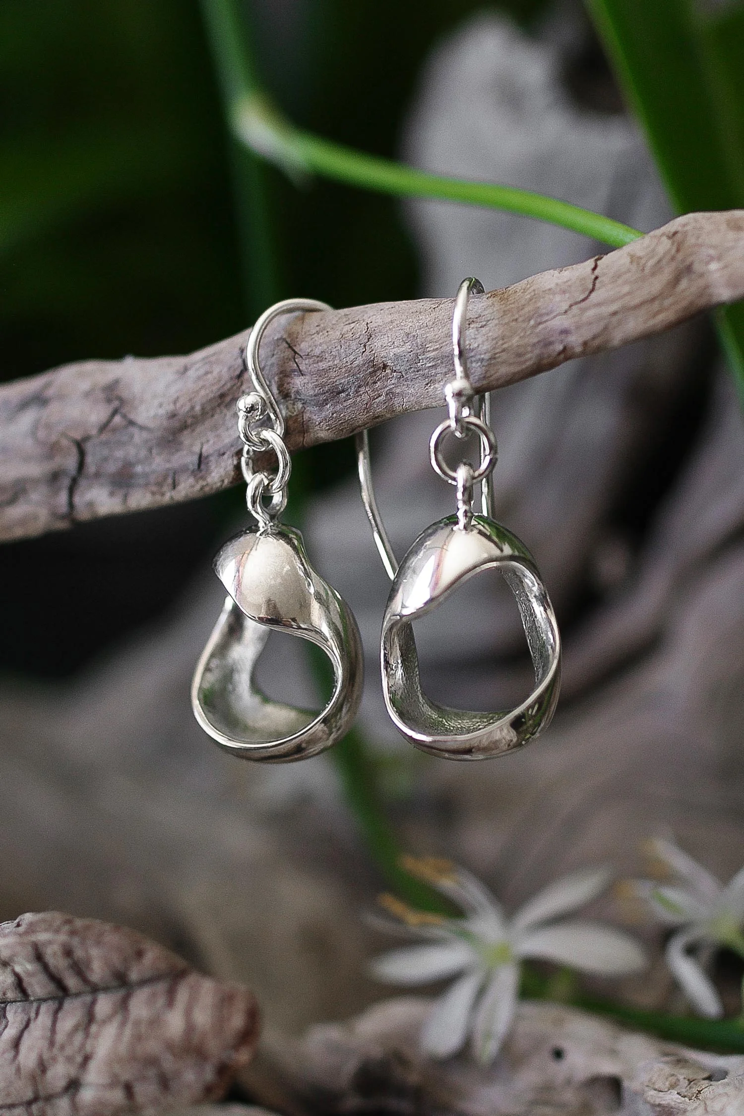 Cradle Earrings sterling silver hanging on driftwood in nature