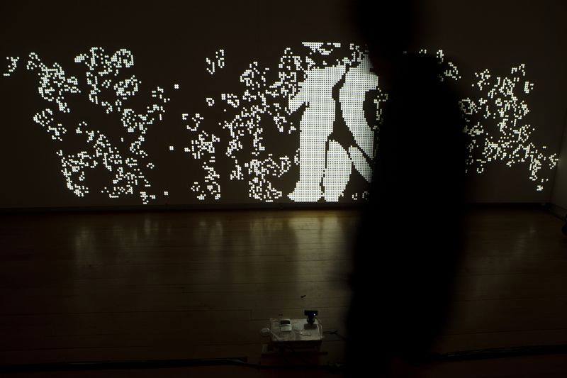 Projection mapping visual interactive installation with a motion sensitive camera