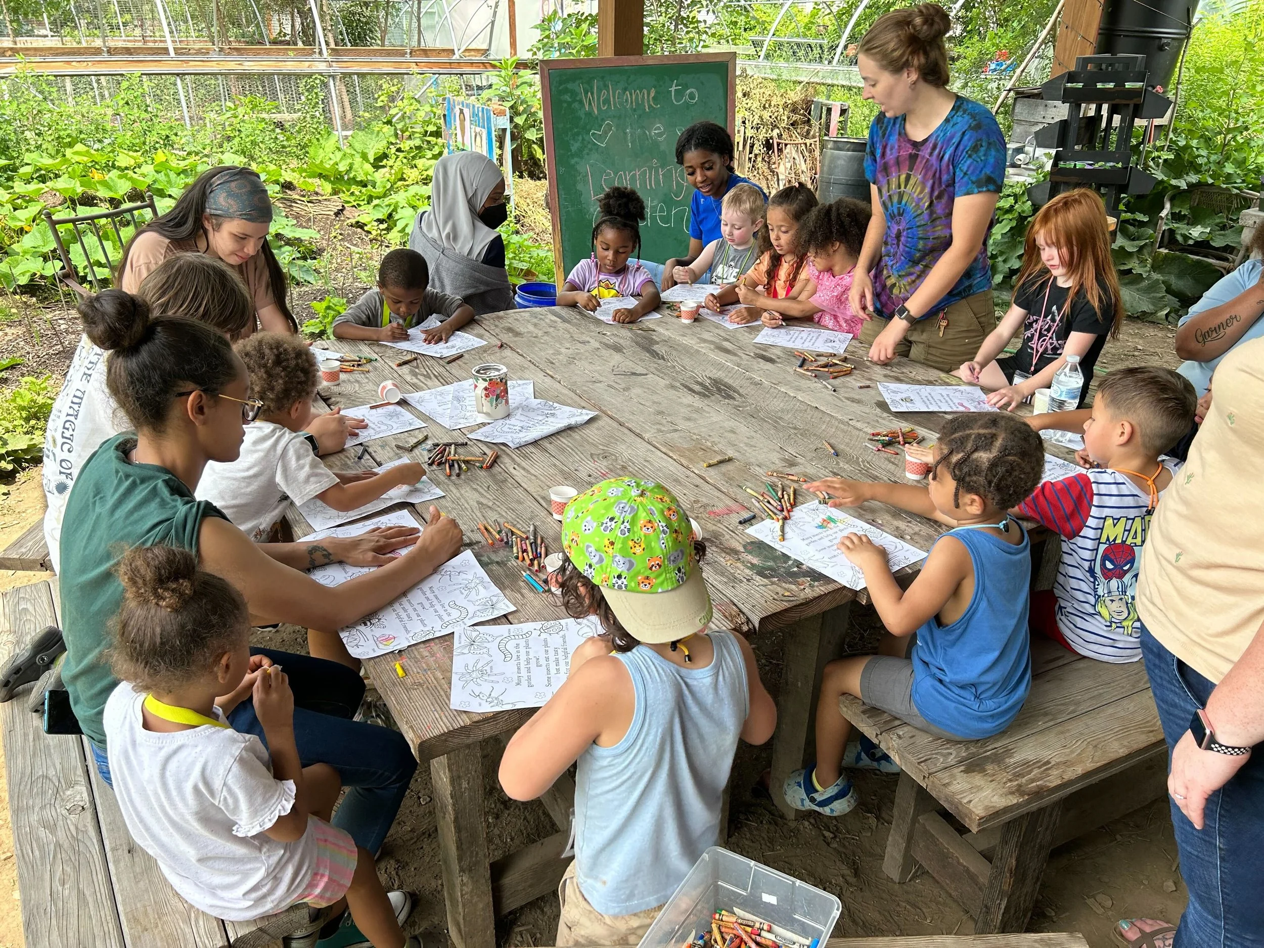Children coloring at an educational event in the Patrick Kaufman Memorial Learning Garden