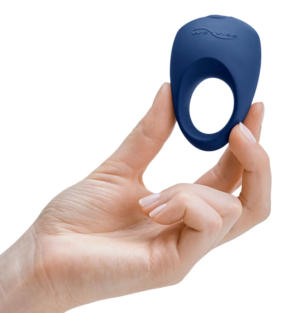 The We-Vibe Pivot, one of the vibrating cock rings available at VaVaVooom. Shown held in a hand.