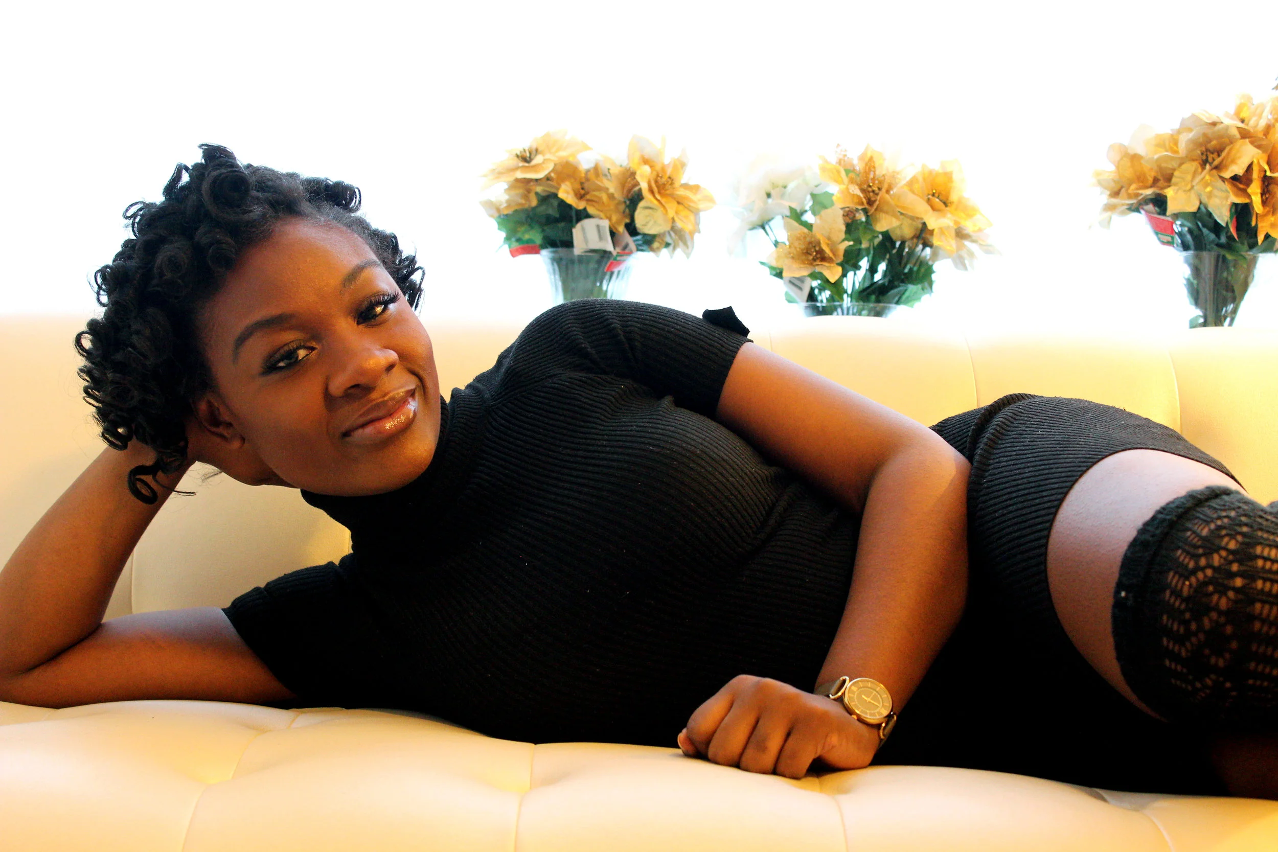 25-year-old Ashley Marston finds comfort in her one-bedroom No-Ma apartment as she lounges on the couch. Photo elements: scale, rule of thirds