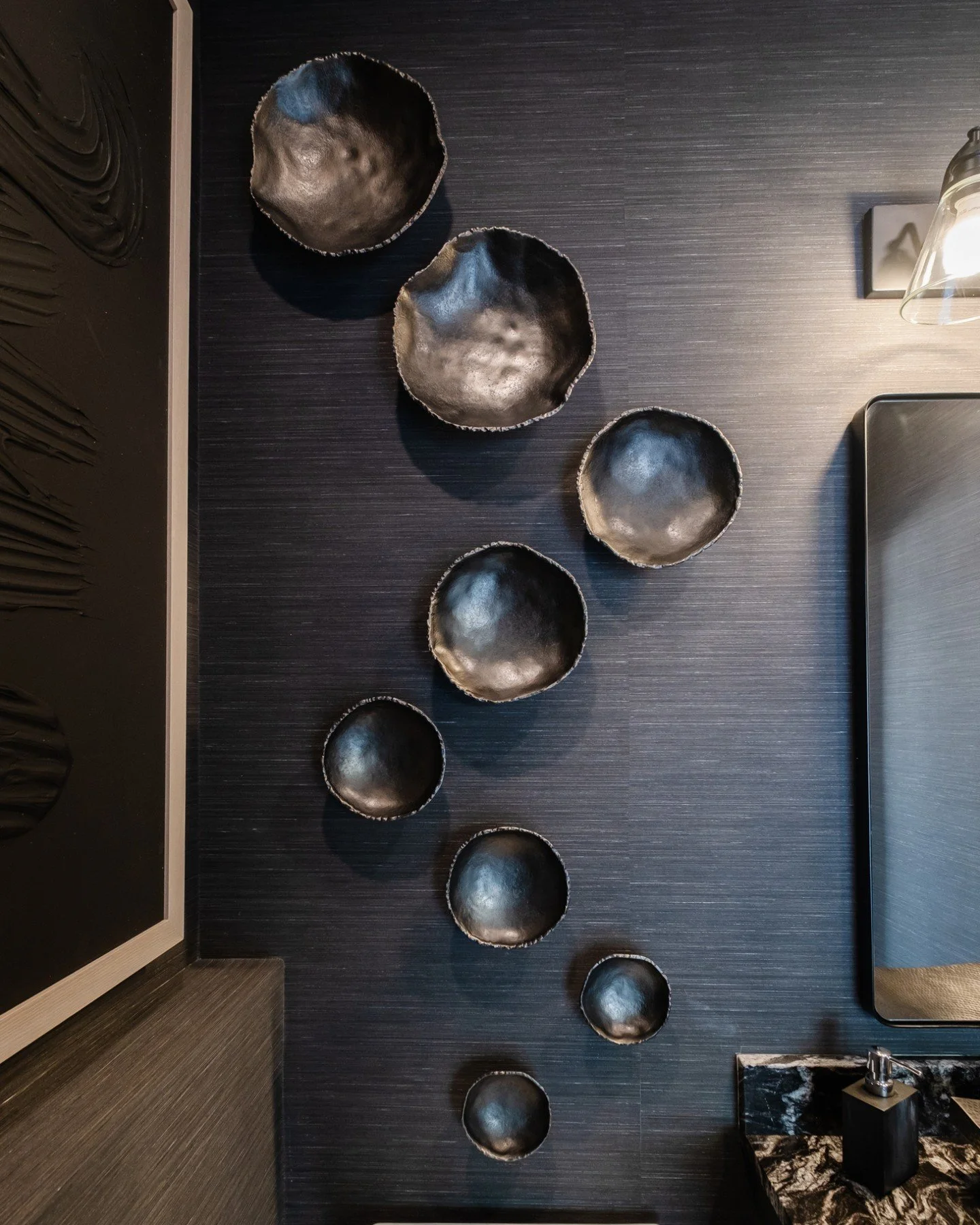 Who says a half bath can&rsquo;t have full personality? With bold black wallpaper and layered textures, this space turns a simple stop into a true style moment. 

Ready to bring a little drama to your own home? Let&rsquo;s design your statement space