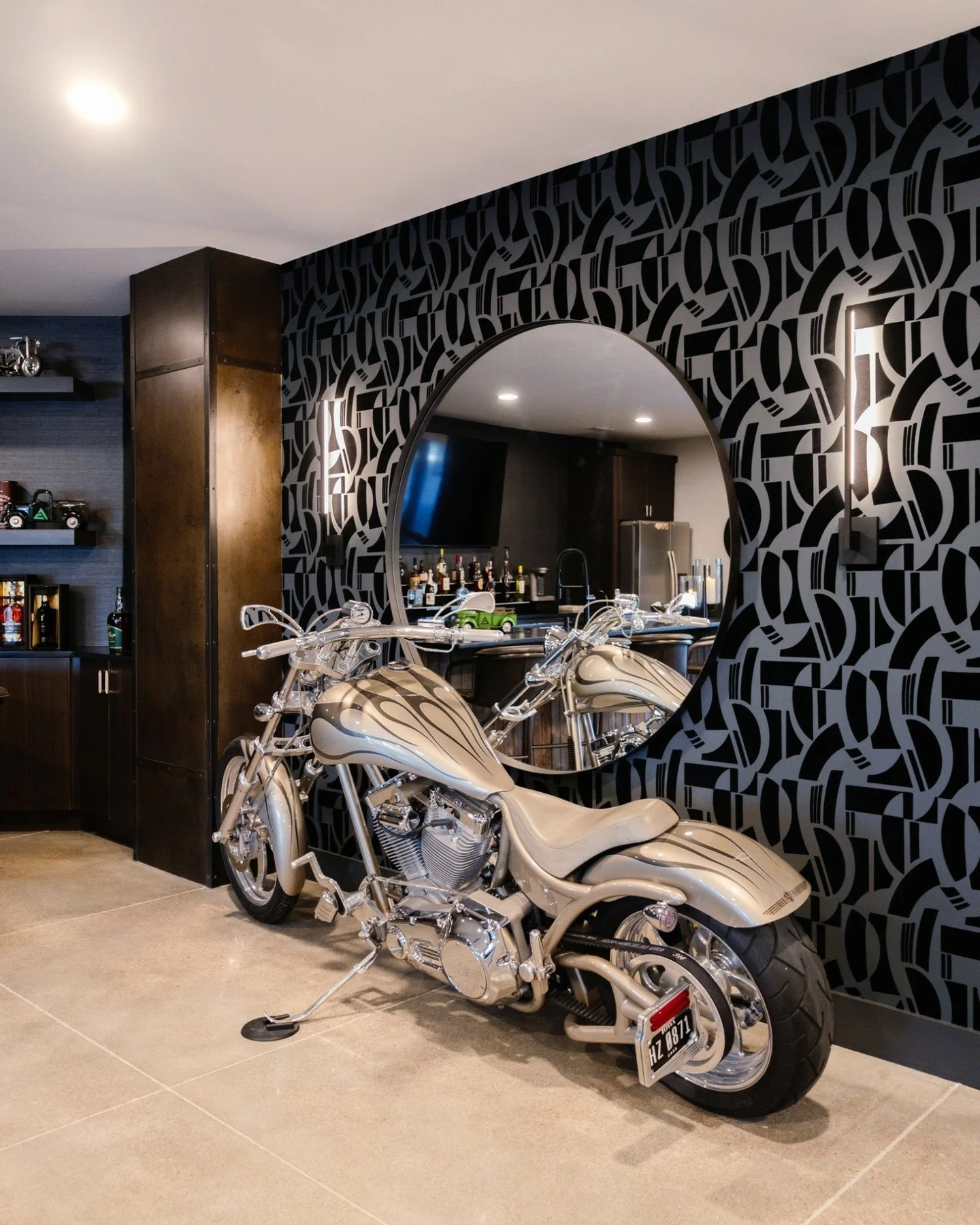 This basement pool table area got a major glow-up &mdash; but the real win? It still feels completely them.

We layered in bold wallpaper, repositioned a piece of art they love, refelted the pool table, and yes&hellip; the motorcycle stayed. Because 