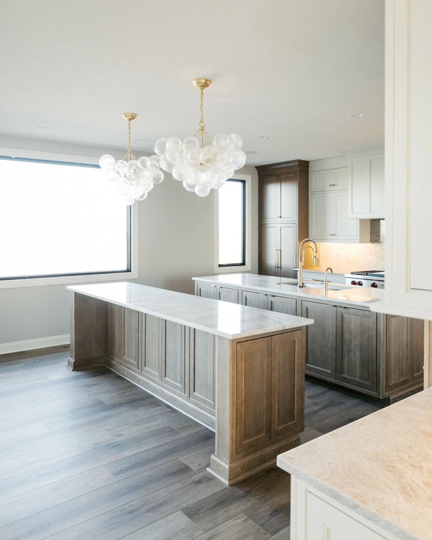 Loving every detail of this kitchen.

Statement lighting, warm brass fixtures, and layered textures set the tone, but the real standout is the double island design. It creates space for cooking, prepping, gathering, and everyday life to happen all at