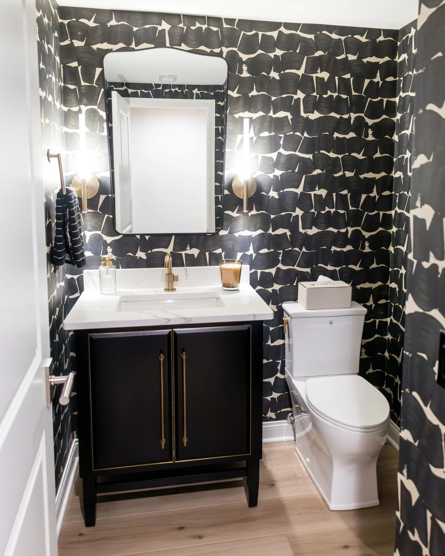 This powder bath went from simple and safe to a statement moment! Where every detail works harder. Dramatic wallpaper, warm brass accents, and a tailored vanity transform this small space into something that leaves a lasting impression.

Proof that t