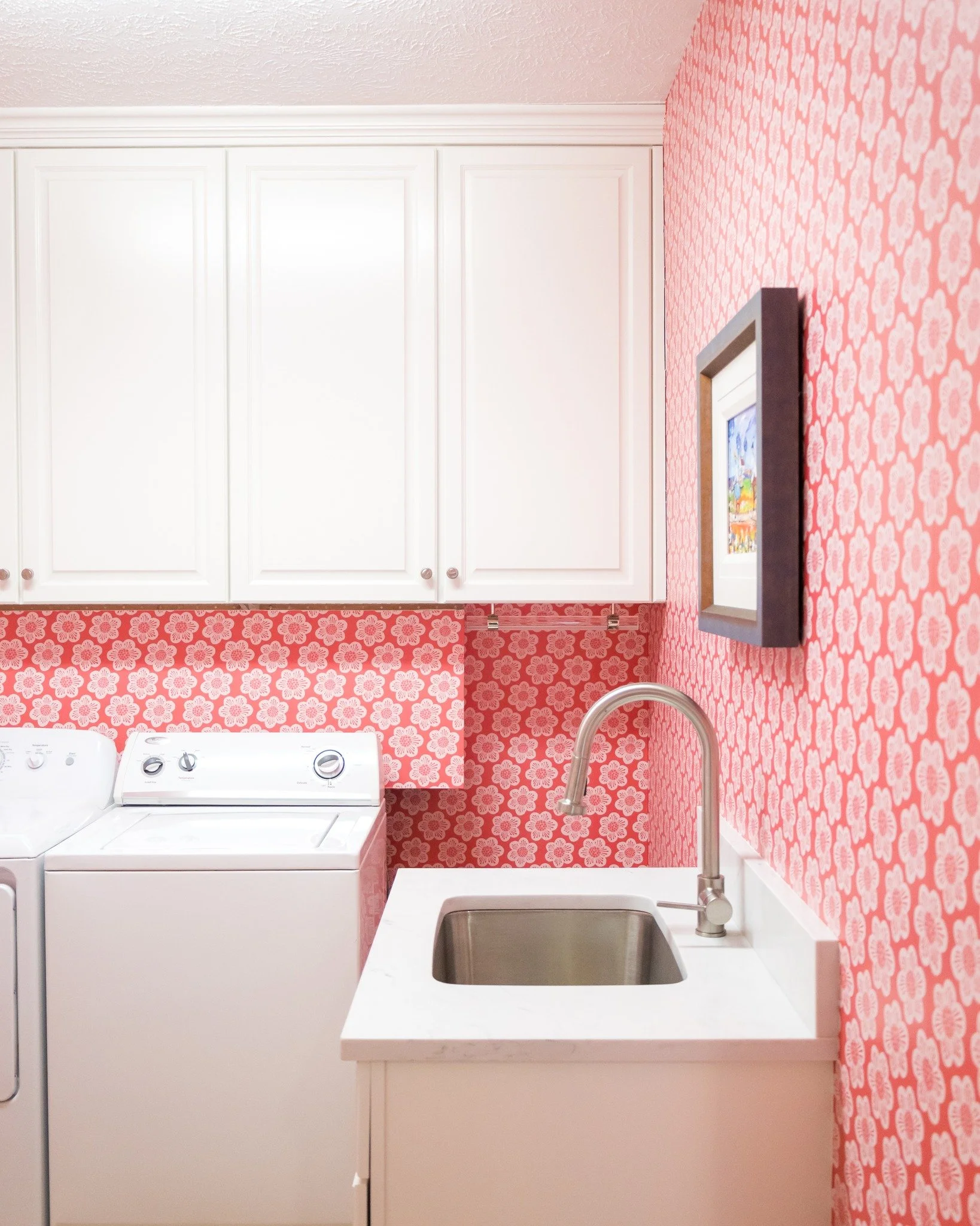 Laundry day just got a whole lot more fun. 🌸

This laundry room glow-up is proof that even the most overlooked spaces deserve some love. We leaned into bold floral wallpaper and bright white cabinetry that not only looks fresh but gave our client so