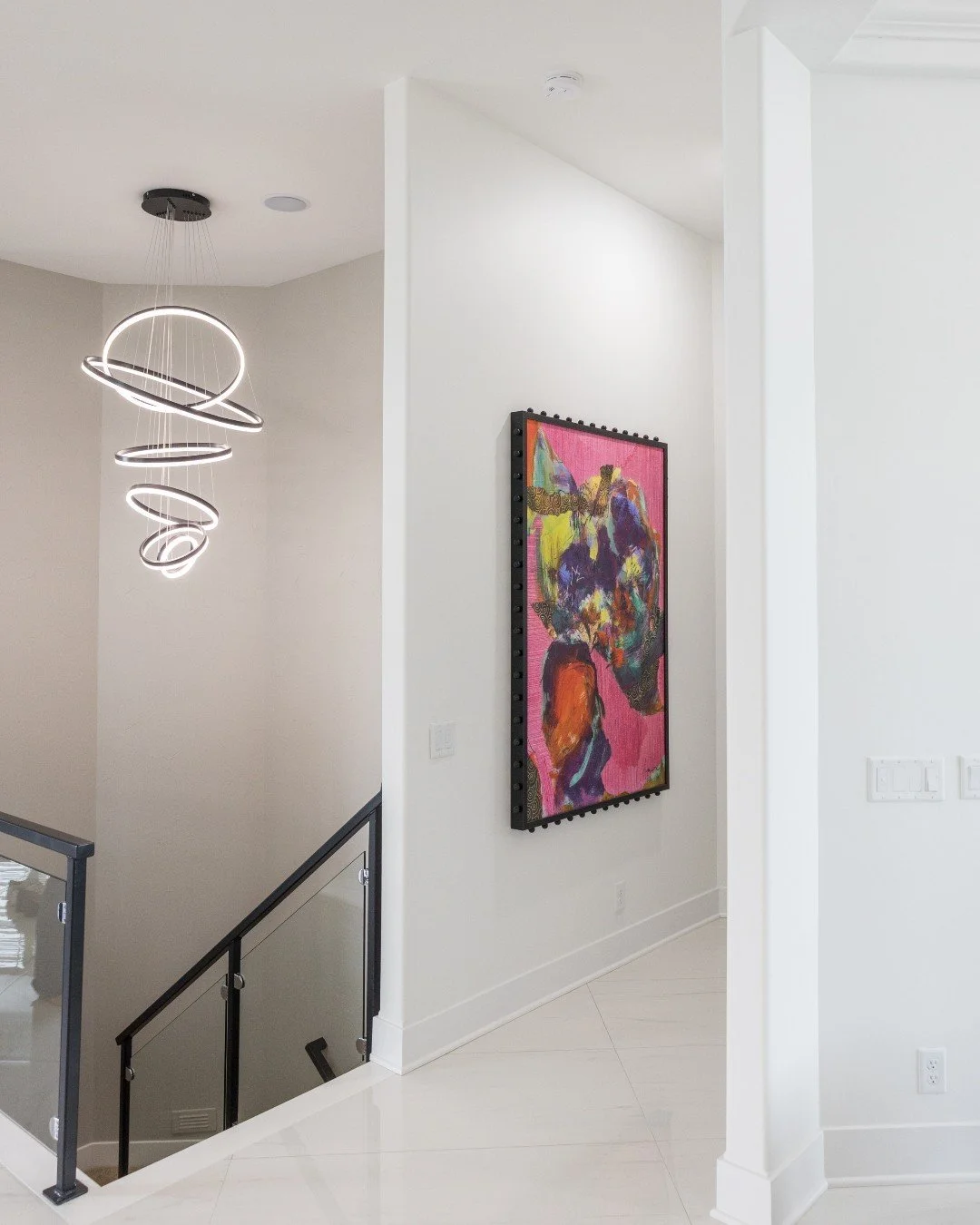 The art in this hallway deserves its own moment!

Bold color. Incredible texture. And that black frame with the ball detailing &mdash; it's a statement piece that earned every inch of wall space it got.

Swipe through the close-ups. You'll see what w
