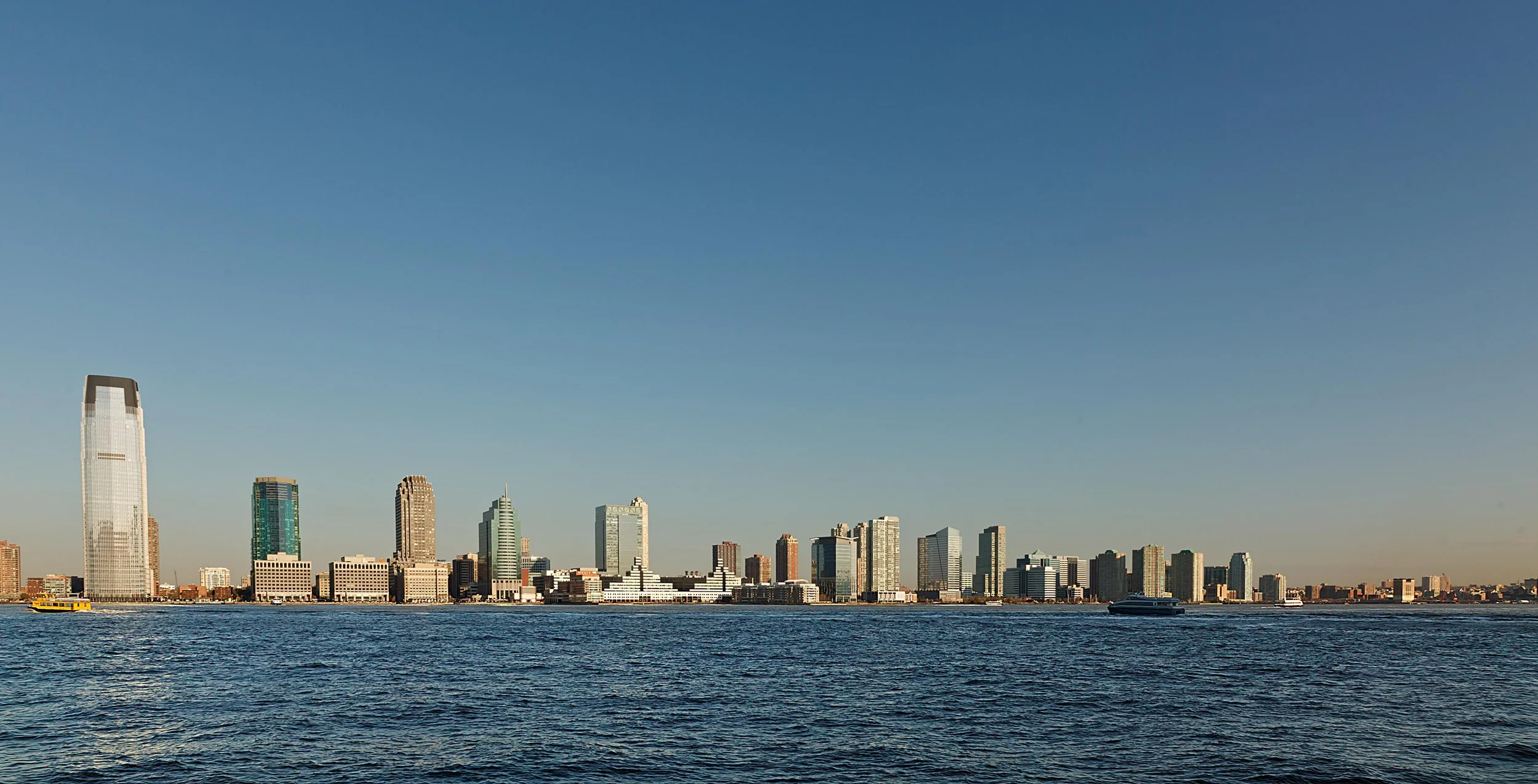 Skyline of Jersey City, New Jersey with skyscrapers and waterfront view.